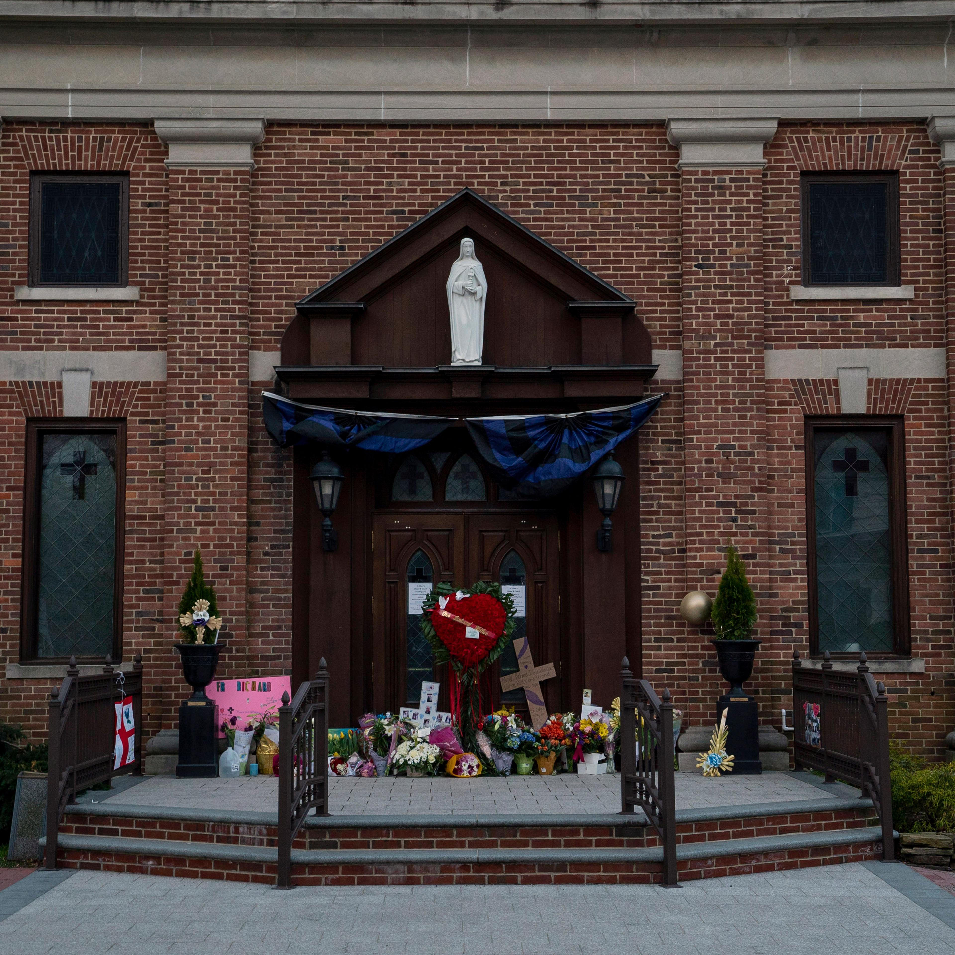 A memorial for Monsignor Richard Guastella, who died from Covid-19 on Thursday, outside the doors of St. Clare Catholic Church in Staten Island, NY, April 10, 2020.