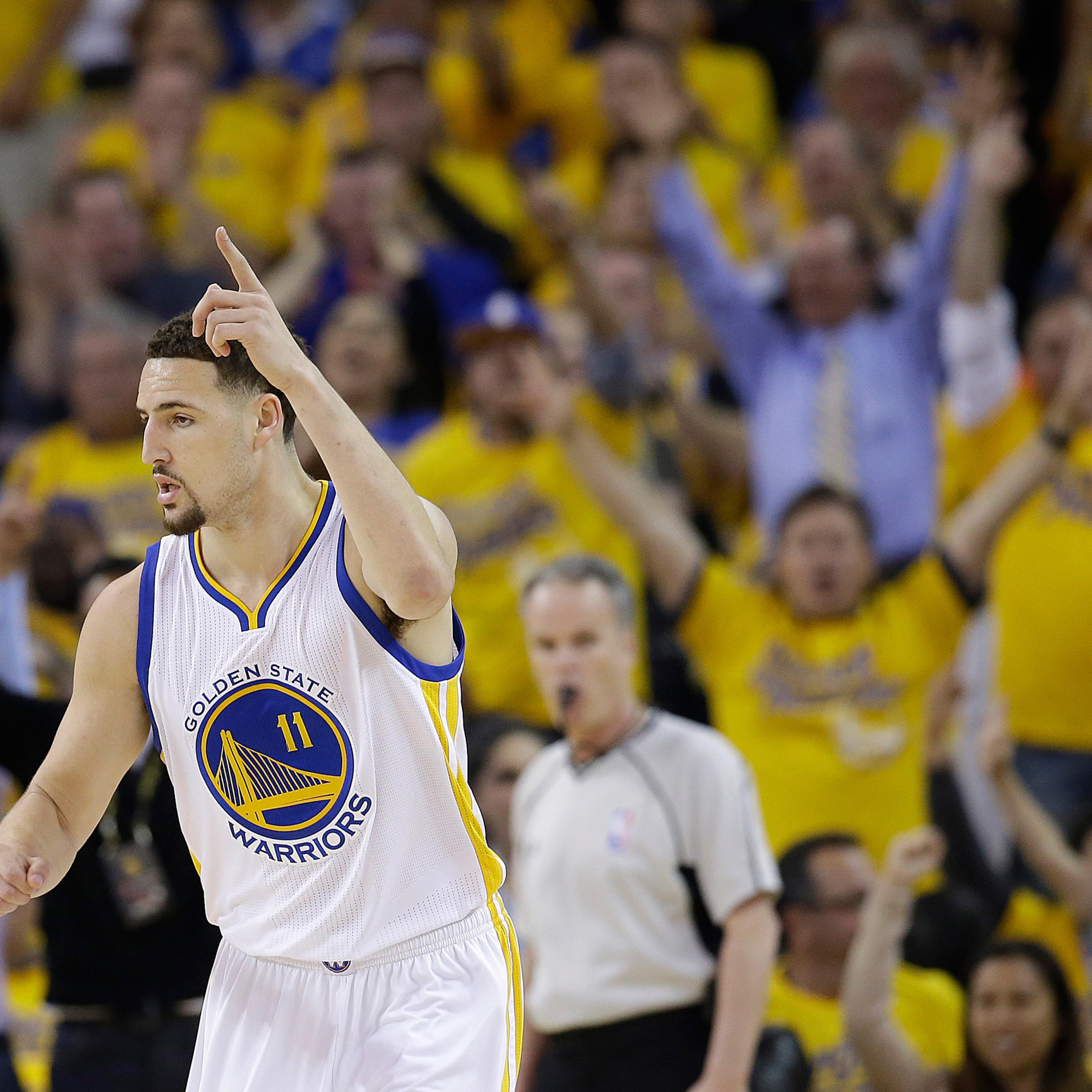 Golden State Warriors guard Klay Thompson (11) reacts after scoring against the Oklahoma City Thunder during the first half of Game 2 of the NBA basketball Western Conference finals in Oakland, Calif., Wednesday, May 18, 2016. (AP Photo/Marcio Jose Sanch
