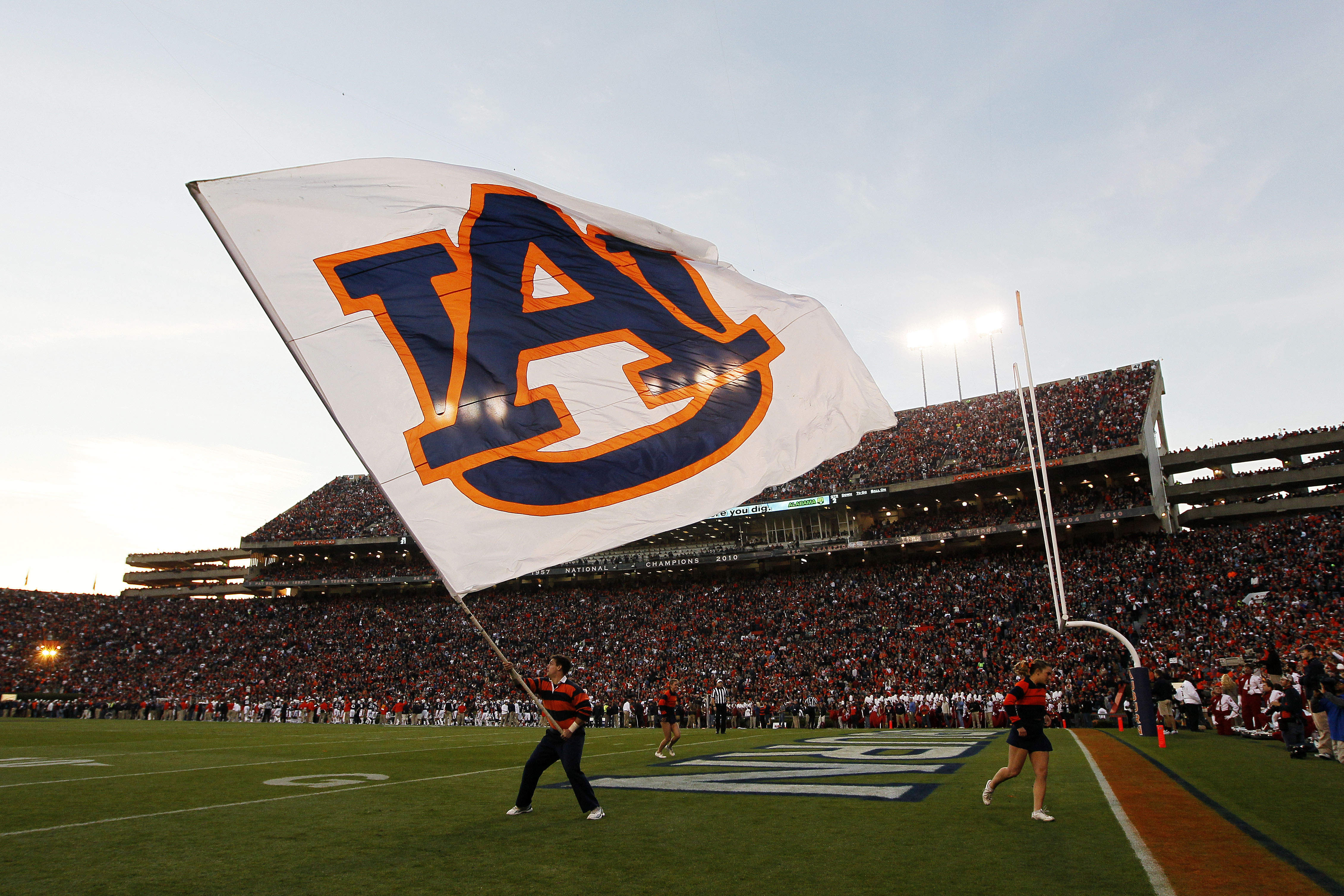 A member of Auburn Tigers cheer team waves a flag during their game against the Alabama Crimson Tide at Jordan-Hare Stadium on Nov. 30, 2013 in Auburn, Ala.
