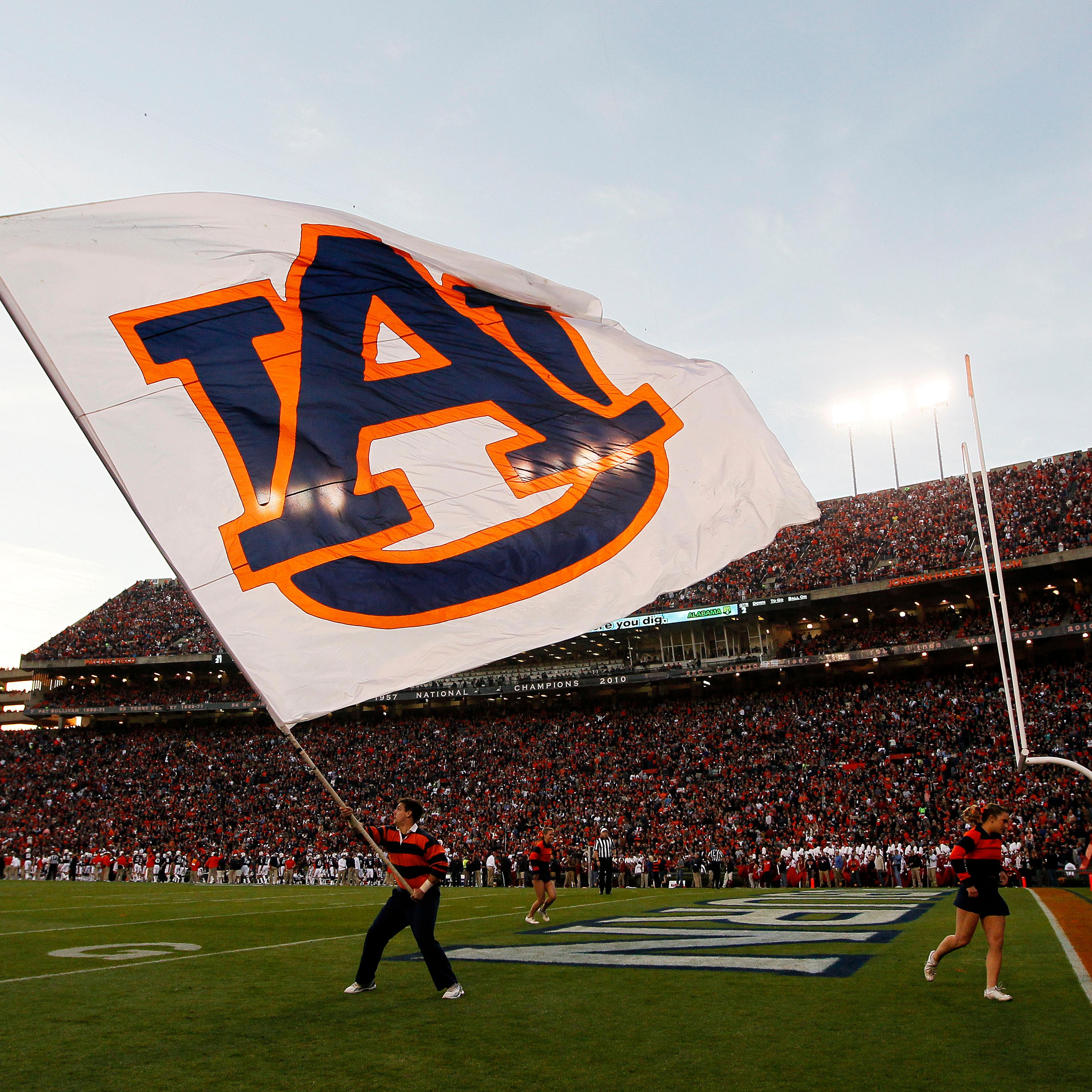 A member of Auburn Tigers cheer team waves a flag during their game against the Alabama Crimson Tide at Jordan-Hare Stadium on Nov. 30, 2013 in Auburn, Ala.