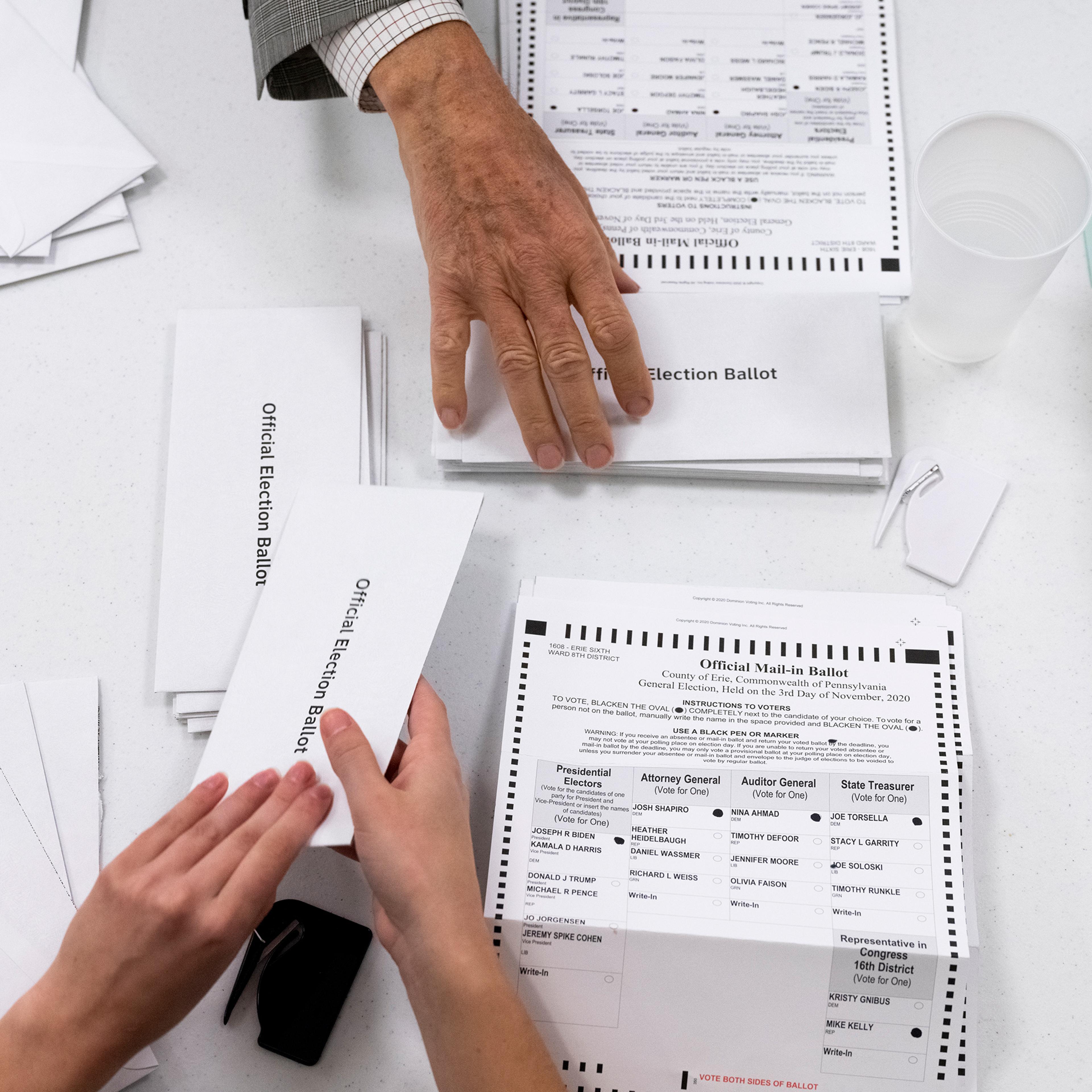 Mailed ballots being opened at an Erie County courthouse on Election Day, the earliest time Pennsylvania allows it