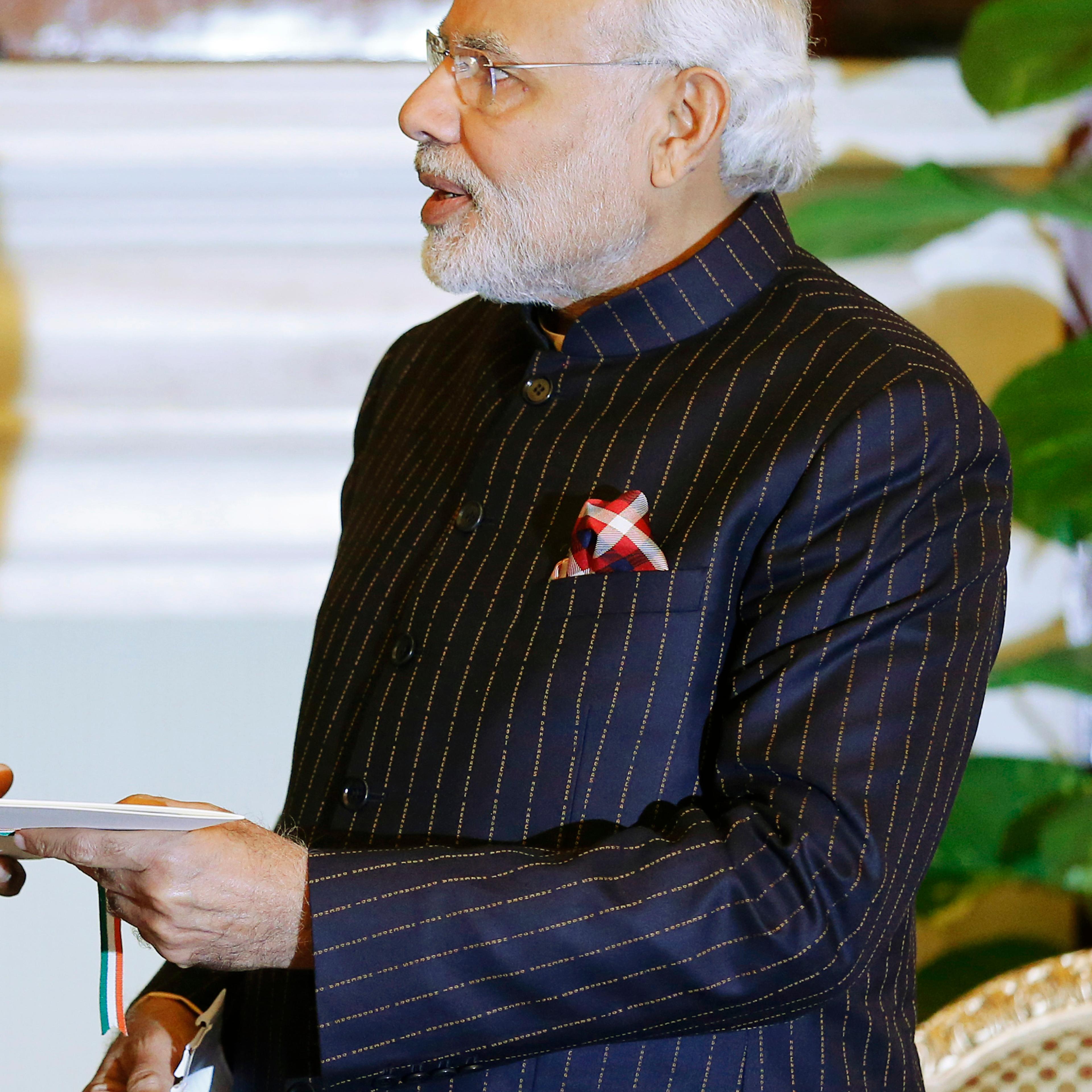 Indian Prime Minister Modi, wearing a dark pinstripe suit repeatedly embroidered with the words "Narendra Damodardas Modi", meets with U.S. President Barack Obama in New Delhi