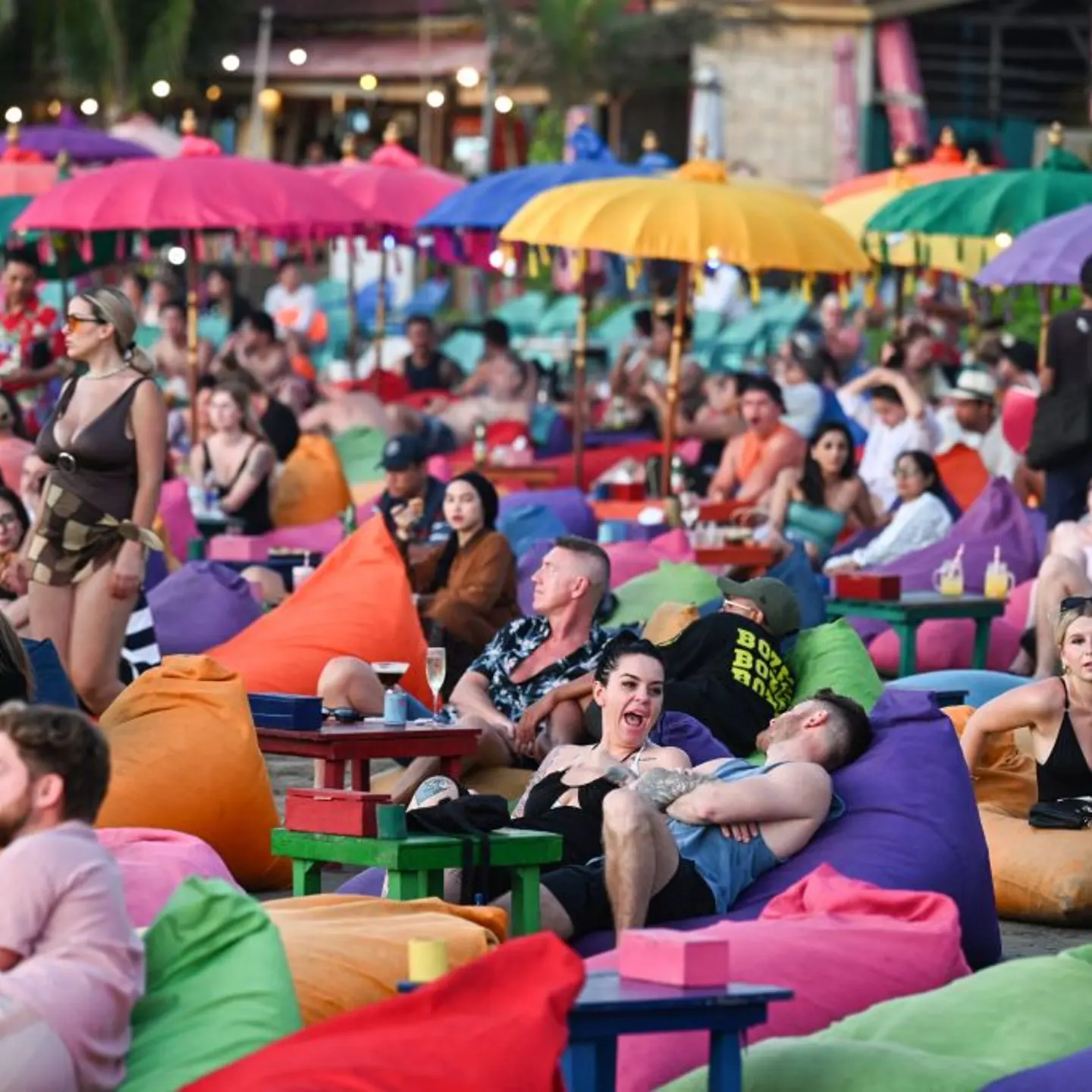 Foreign tourists relax on the Kuta Beach near Denpasar on Indonesia's resort island of Bali on Nov. 18, 2023.
