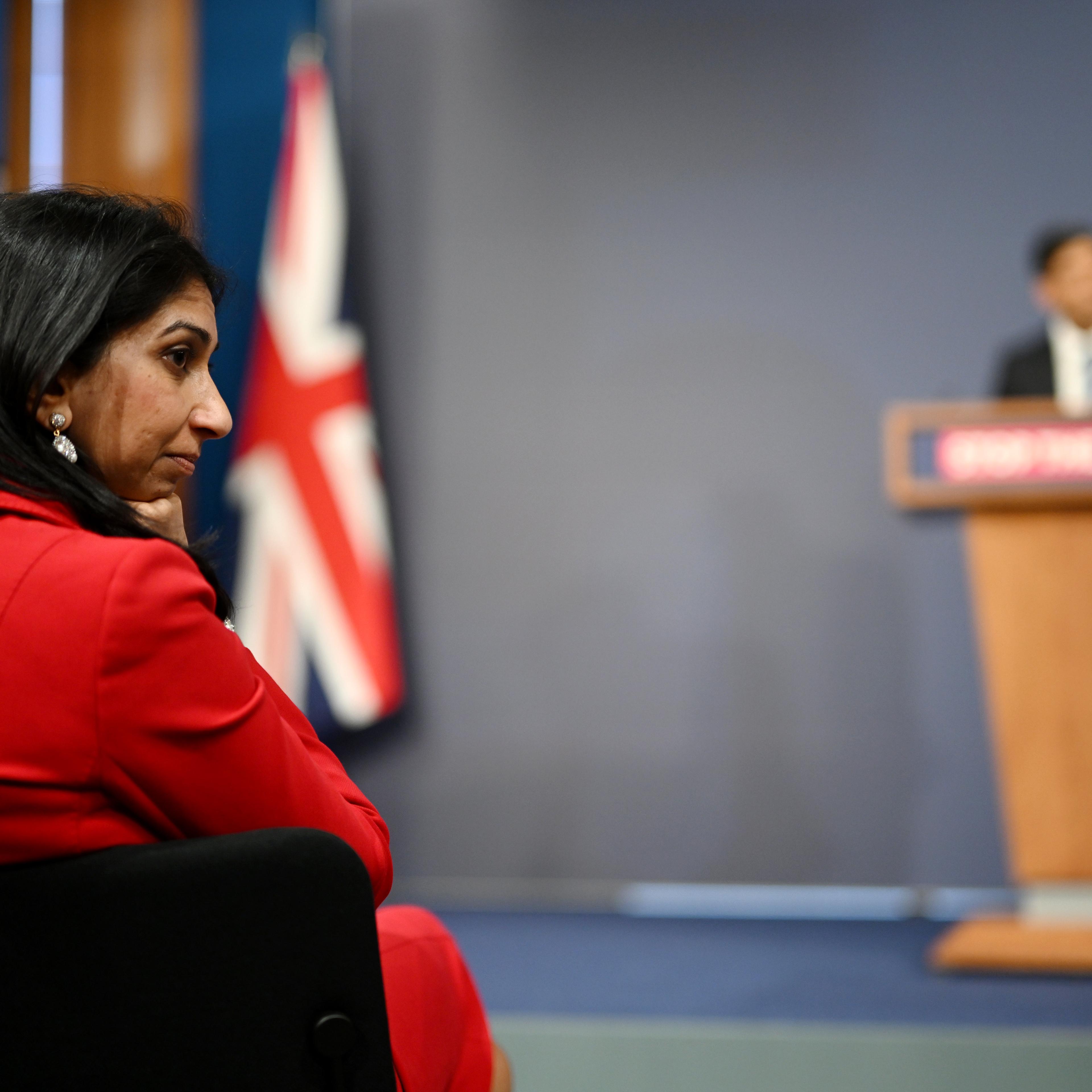 Home Secretary Suella Braverman listens as Prime Minister Rishi Sunak speaks during a press conference following the launch of new legislation on migrant channel crossings at Downing Street on March 7, 2023 in London.