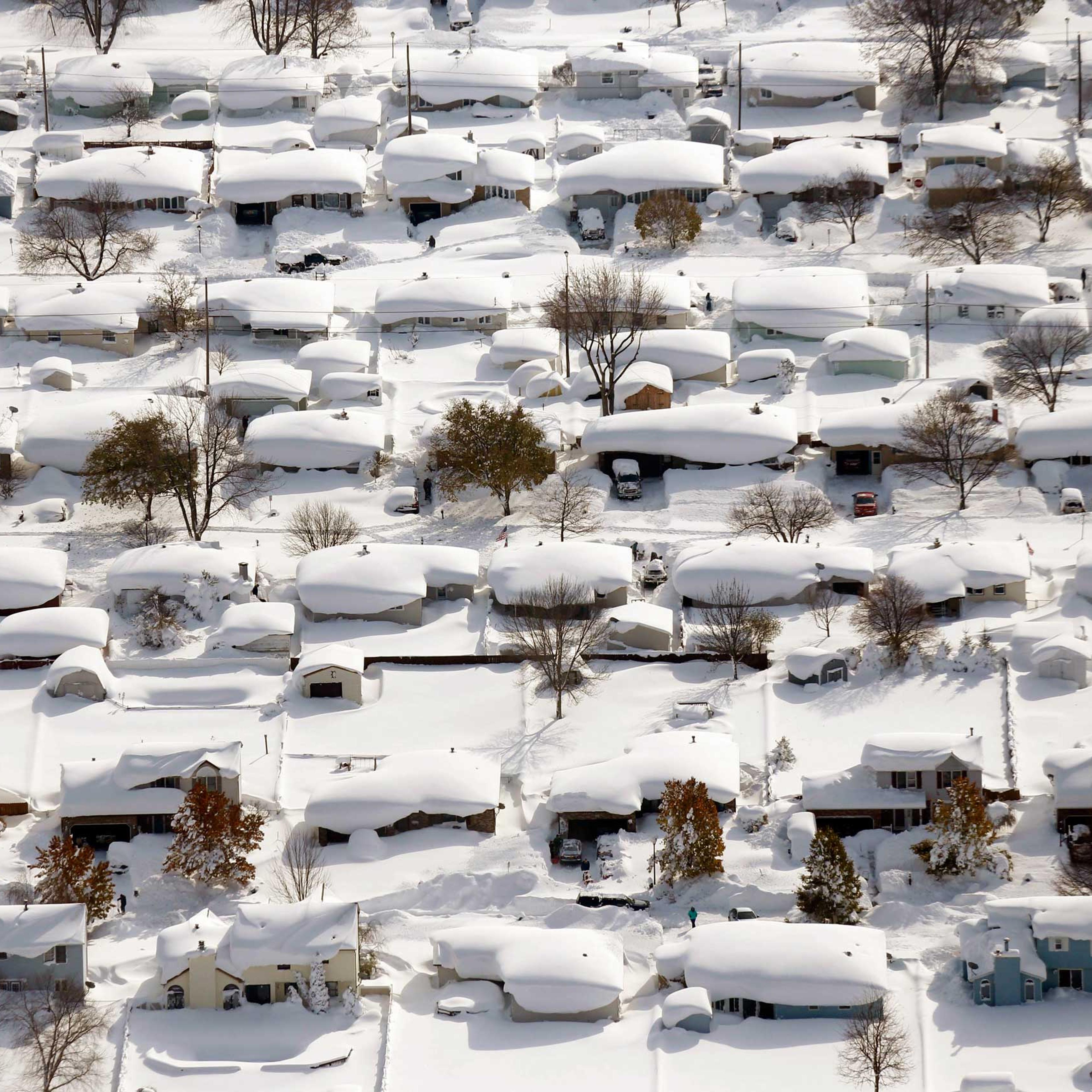 Homes are covered in snow in West Seneca, N.Y. on Nov. 19, 2014. The Buffalo area found itself buried under as much as 5½ feet of snow with another lake-effect storm expected to bring 2 to 3 more feet.