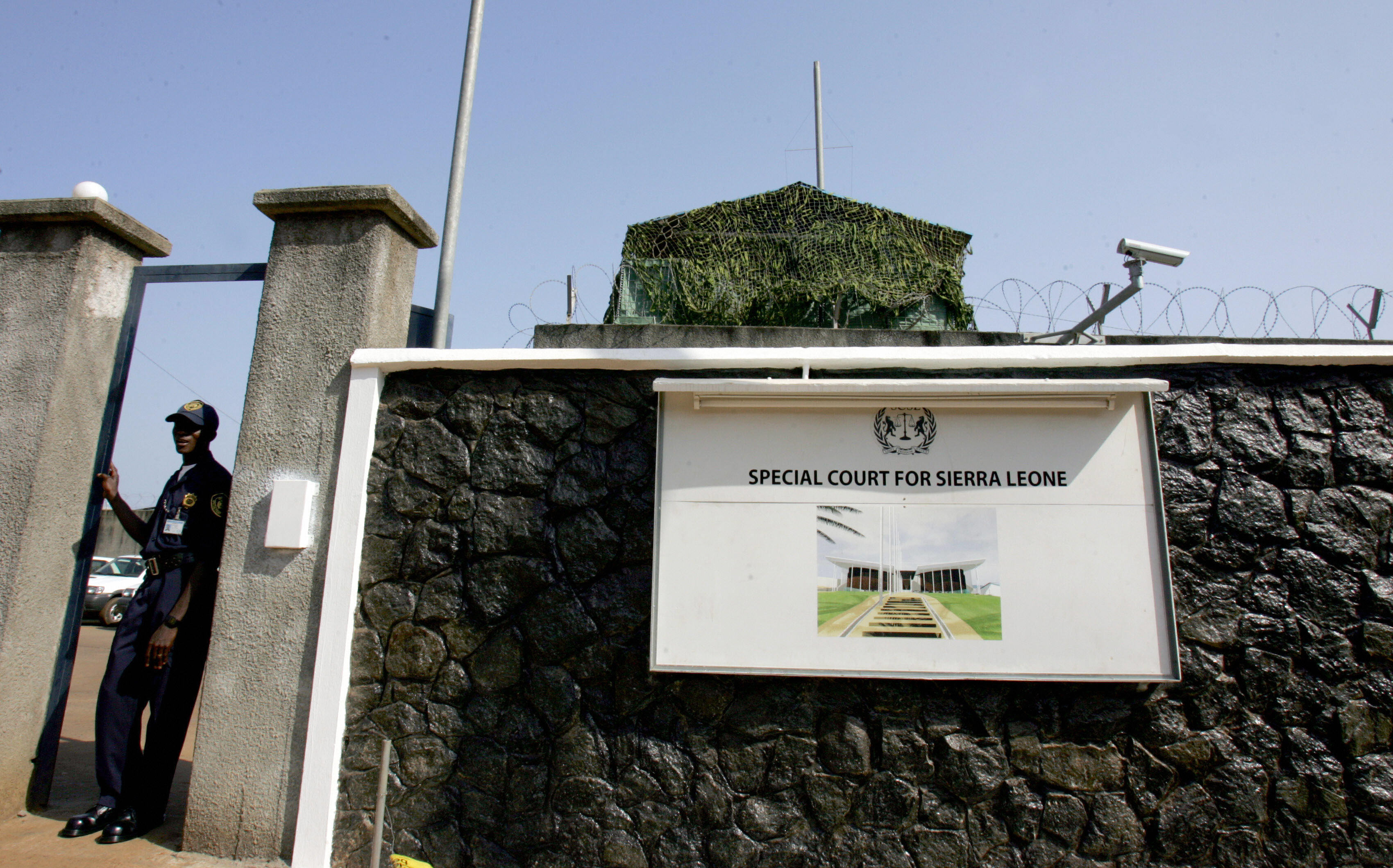 A soldier exits the United Nations mission to Sierra Leone on March 31, 2006 in front of the gate of the Special Court for Sierra Leone.