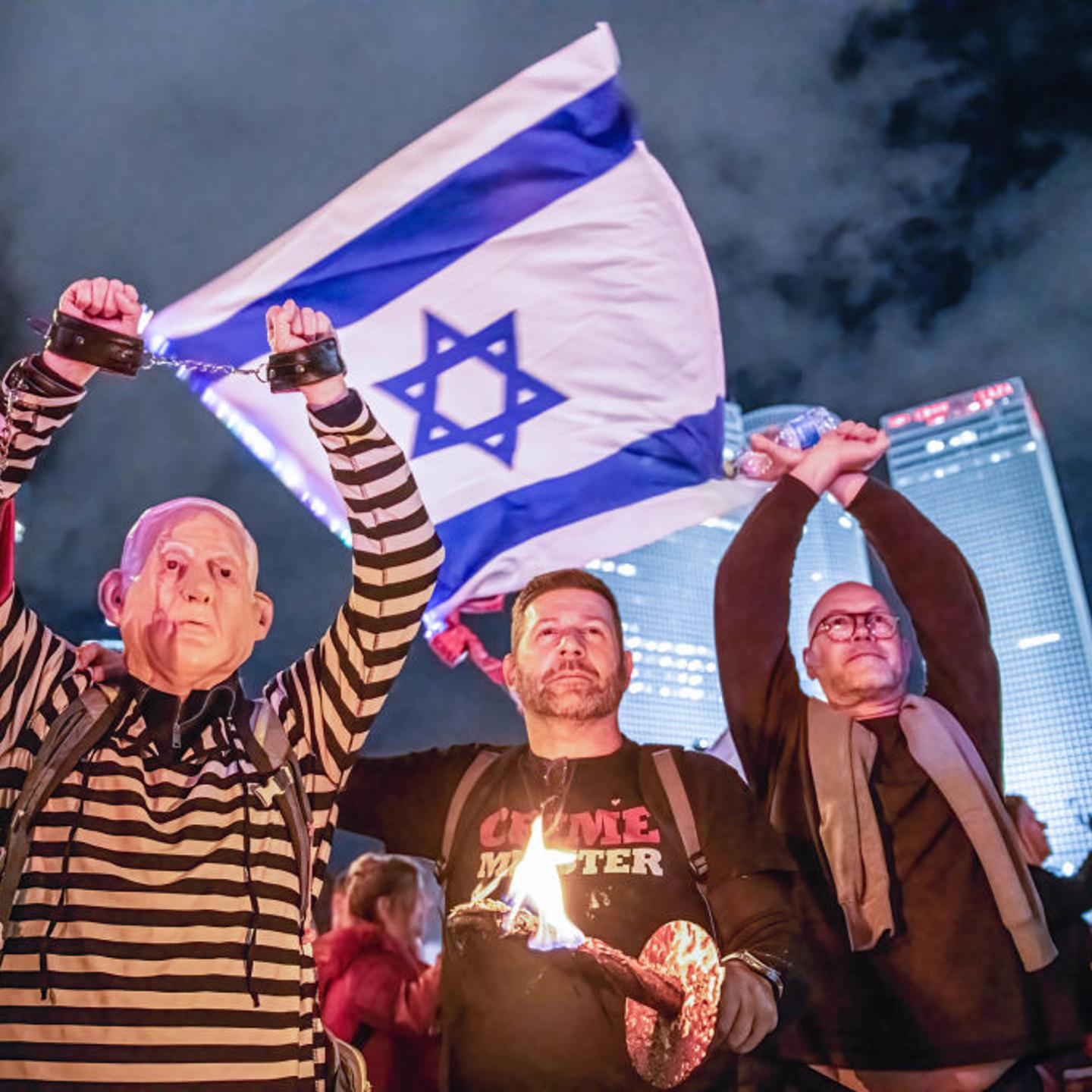Israeli protester dressed in a convict uniform and a