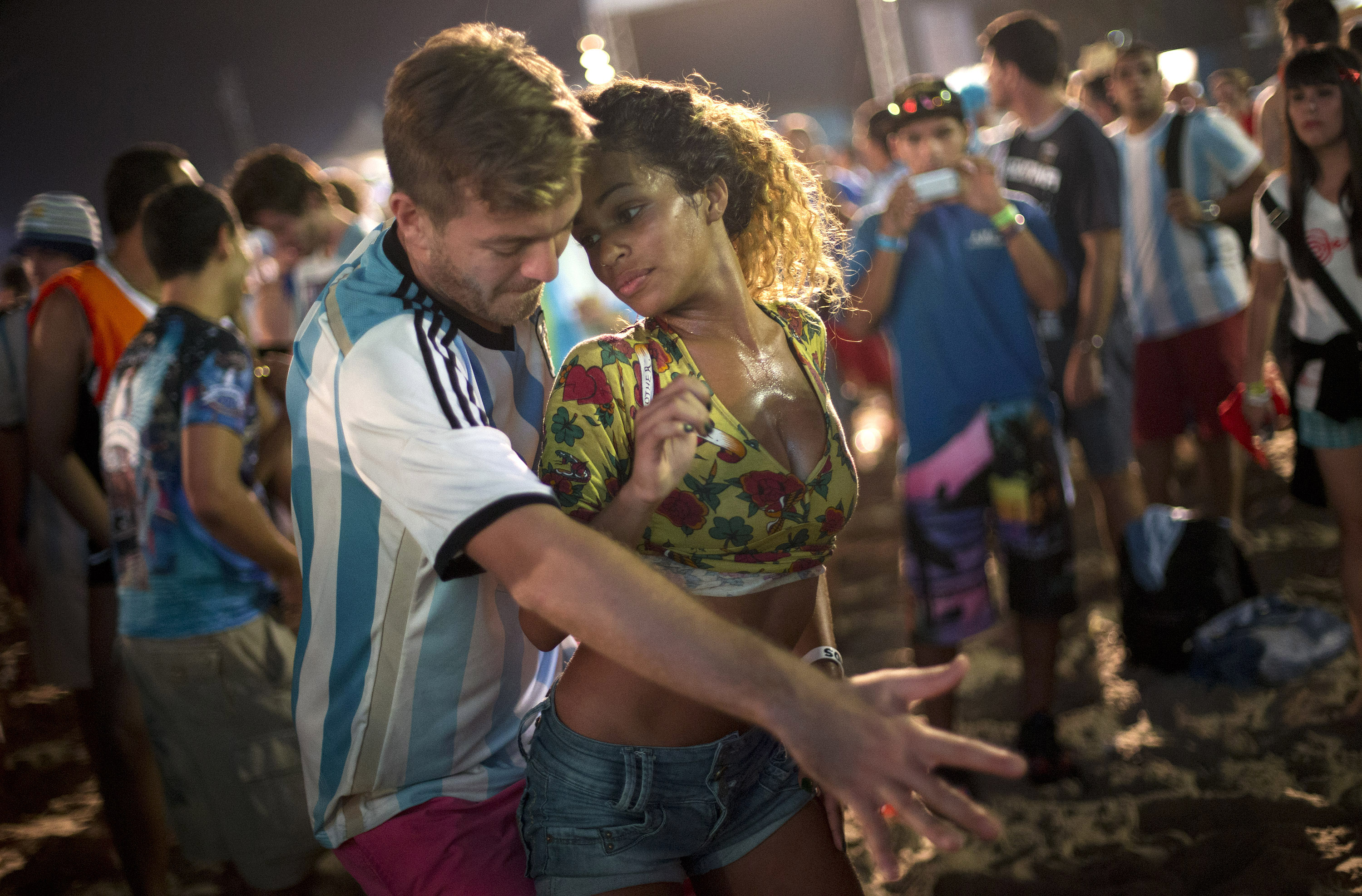 A woman from Brazil and a man from Argentina dance samba at the World Cup Fan Fest 2014, on Copacabana beach, in Rio de Janeiro on July 9, 2014.
