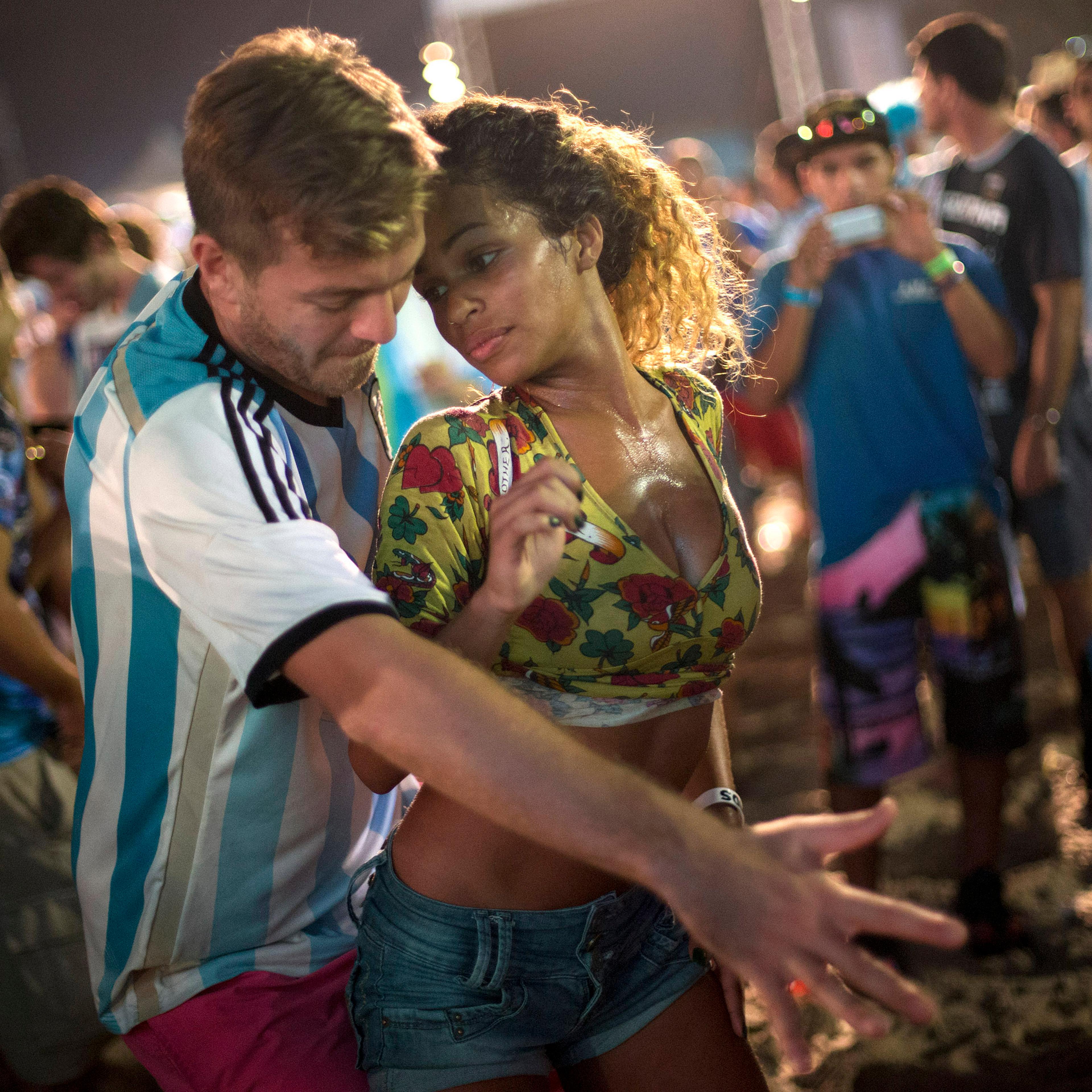 A woman from Brazil and a man from Argentina dance samba at the World Cup Fan Fest 2014, on Copacabana beach, in Rio de Janeiro on July 9, 2014.