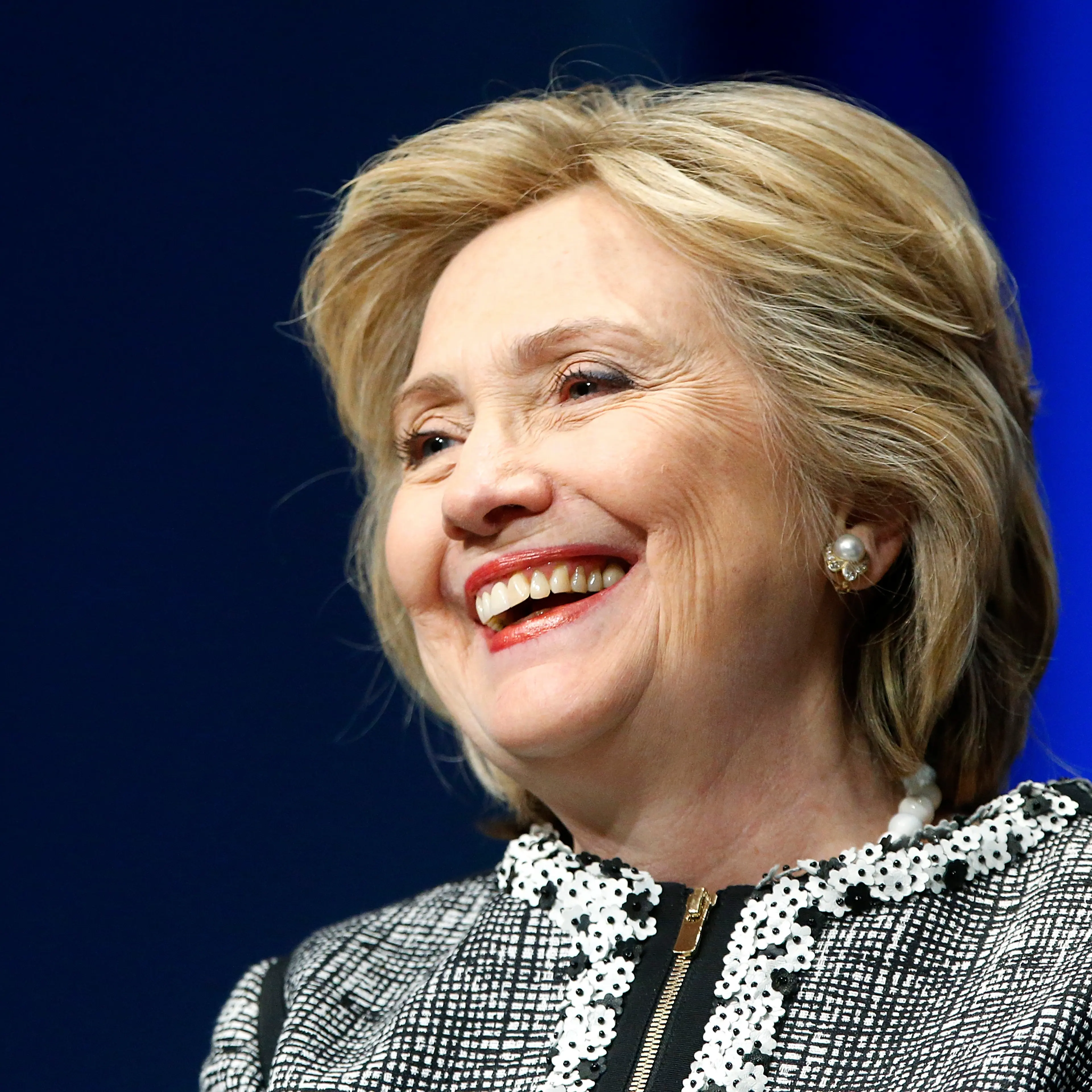Former U.S. Clinton smiles during a lengthy ovation for her at the start of an event on empowering woman and girls, at the World Bank in Washington
