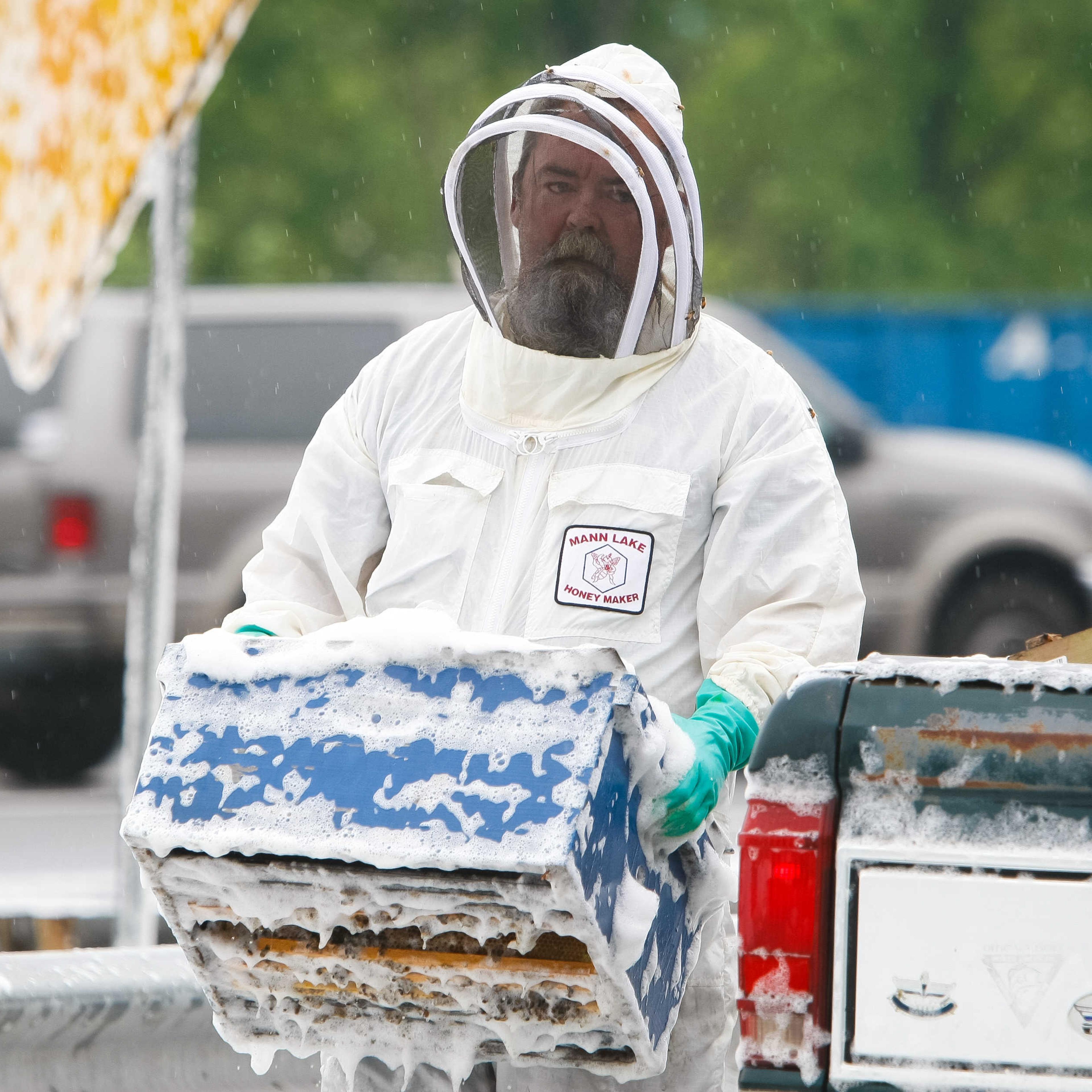 A beekeeper continues to collect bee hive containers scattered along I-95 near Newark, Delaware Wednesday, May 21, 2014.