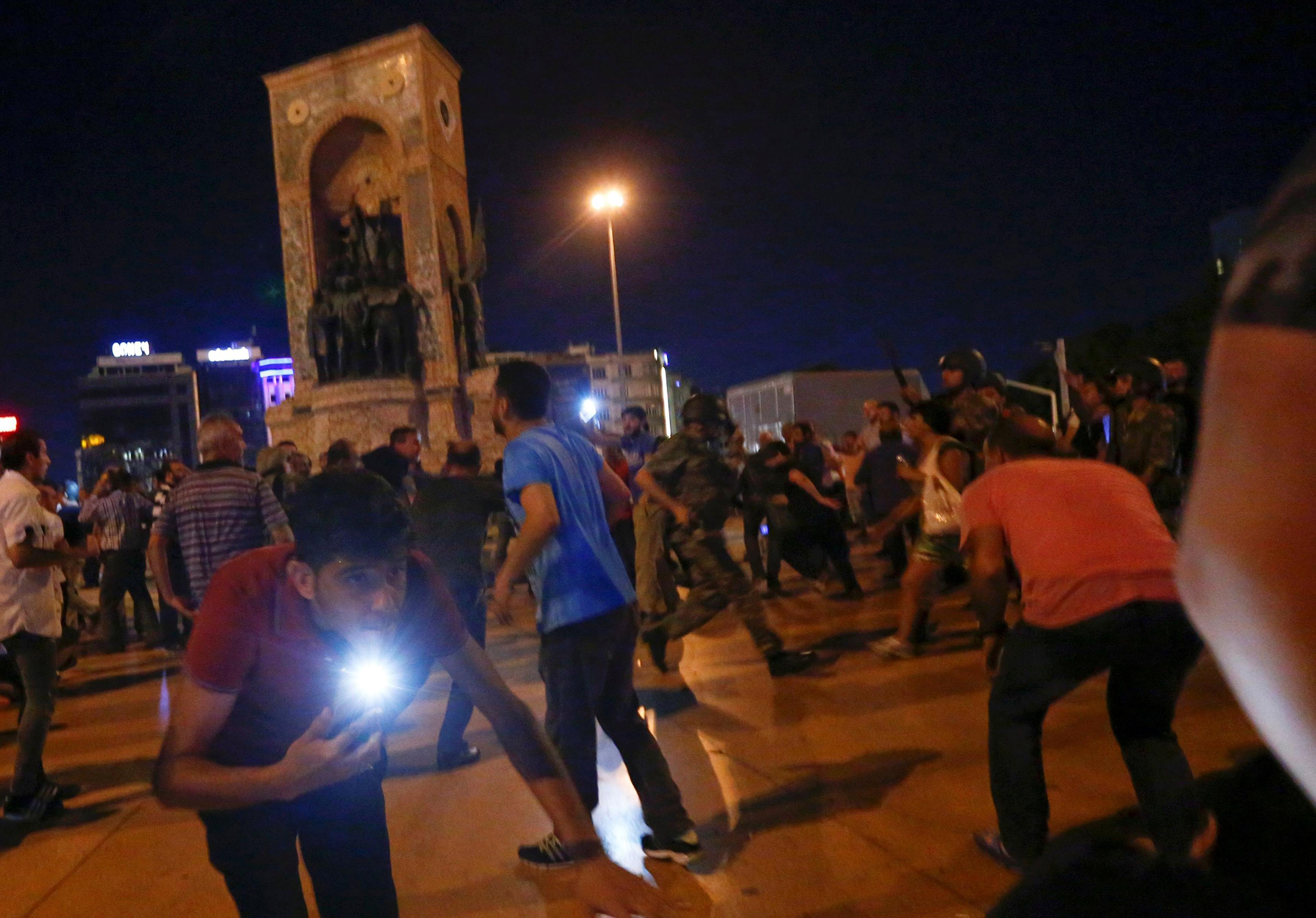 Supporters of Turkish President Recep Tayyip Erdogan are dispersed with shots in the air by the military at Taksim Square in Istanbul, Turkey, on July 16, 2016.