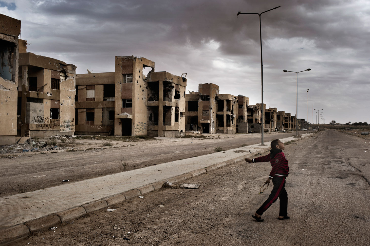 March 31, 2012. Children play with slingshots in Sirte, the late Libyan dictator Muammar Gaddafi’s hometown. Sirte was one of the last loyalist strongholds in the nearly year-long war that ended the 42-year regime of Muammar Gaddafi, and it sustained more damage than any other Libyan city—in just a little over a month of heavy fighting. Many residents who admit to having been Gaddafi supporters now worry about what will become of them in the new Libya.