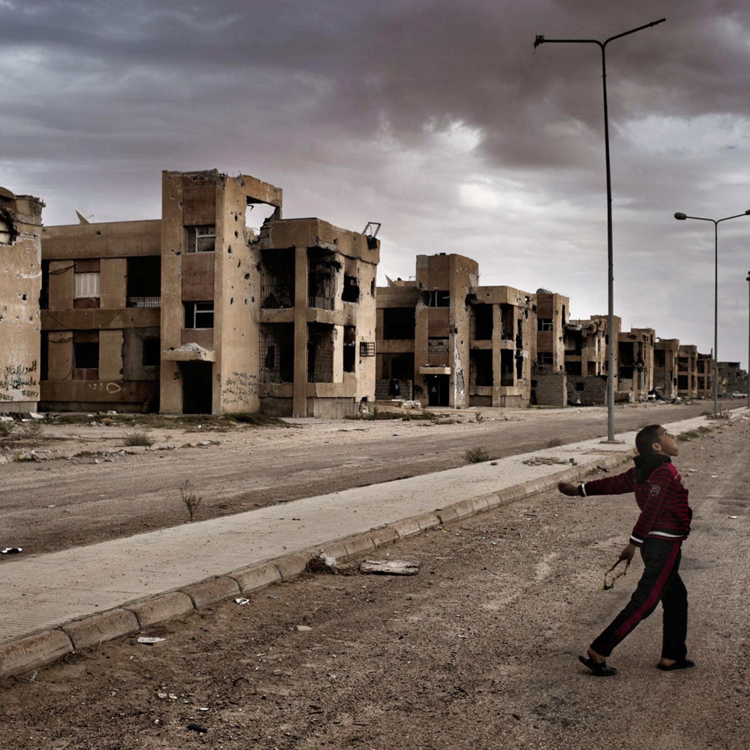 March 31, 2012. Children play with slingshots in Sirte, the late Libyan dictator Muammar Gaddafi’s hometown. Sirte was one of the last loyalist strongholds in the nearly year-long war that ended the 42-year regime of Muammar Gaddafi, and it sustained more damage than any other Libyan city—in just a little over a month of heavy fighting. Many residents who admit to having been Gaddafi supporters now worry about what will become of them in the new Libya.