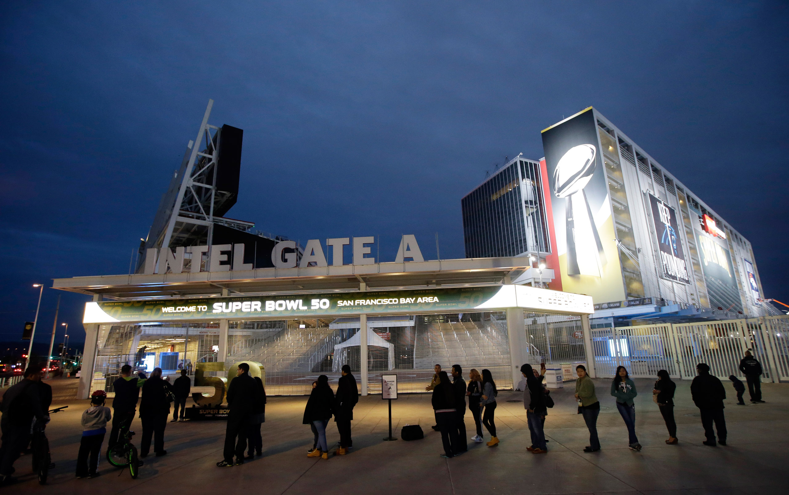 Visitors line up to pose for photos outside of Levi's Stadium Saturday, Jan. 30, 2016, in Santa Clara, Calif. Super Bowl 50, between the Carolina Panthers and Denver Broncos, will be played at Levi's Stadium Feb. 7. (AP Photo/Marcio Jose Sanchez)