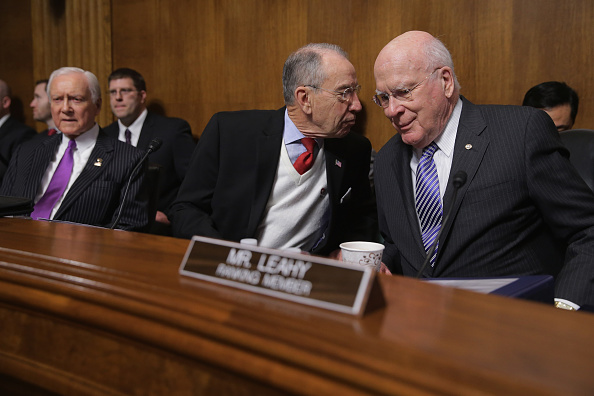 Senate Judiciary Committee Chairman Chuck Grassley (R-IA) (C) speaks with ranking member Sen. Patrick Leahy (D-VT) before a hearing about he impact of heroin and prescription drug abuse in the Dirksen Senate Office Building on Capitol Hill January 27, 20