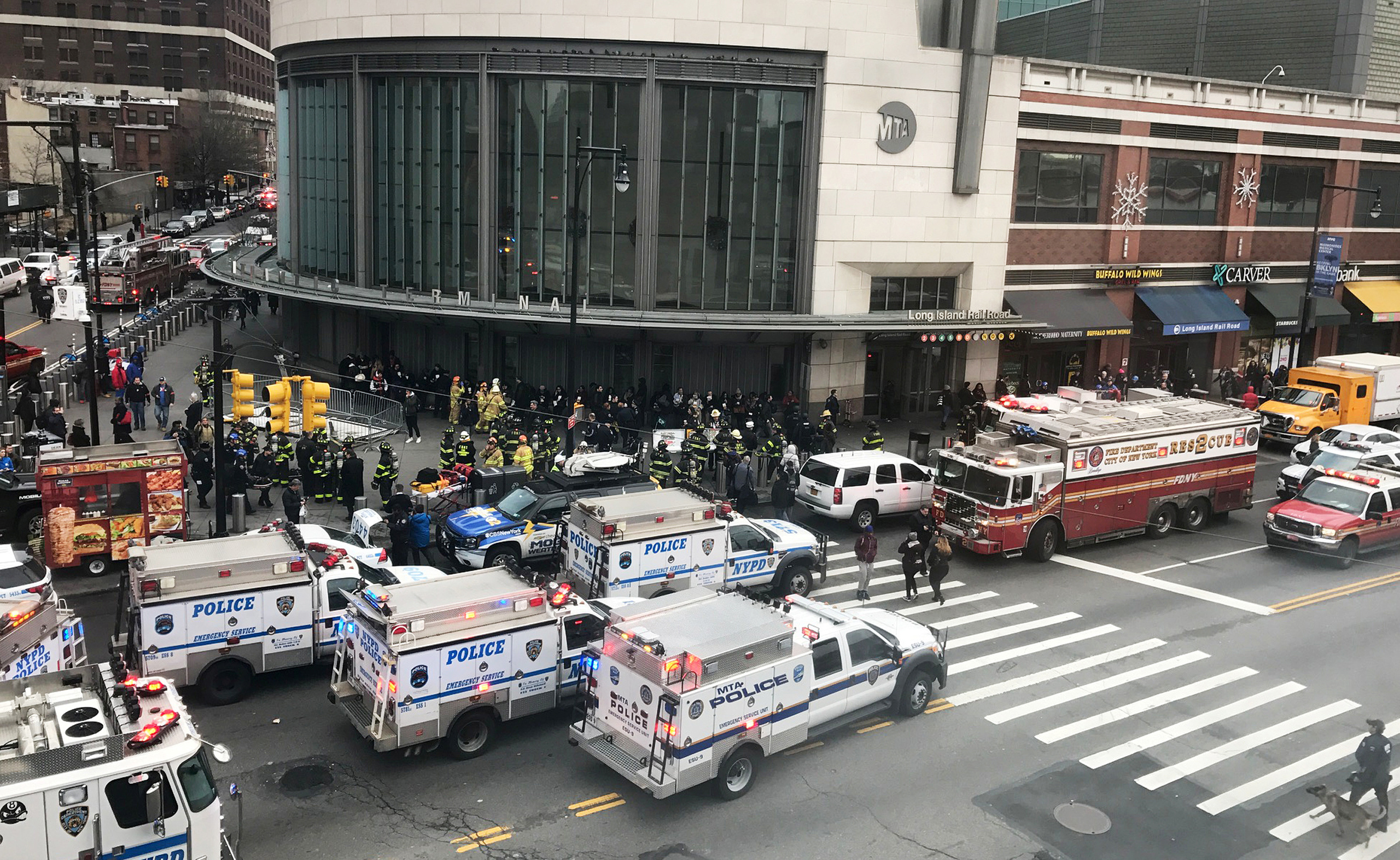 Emergency vehicles gather at the Atlantic Avenue Terminal after a commuter train derailed during the Wednesday morning commute, in New York