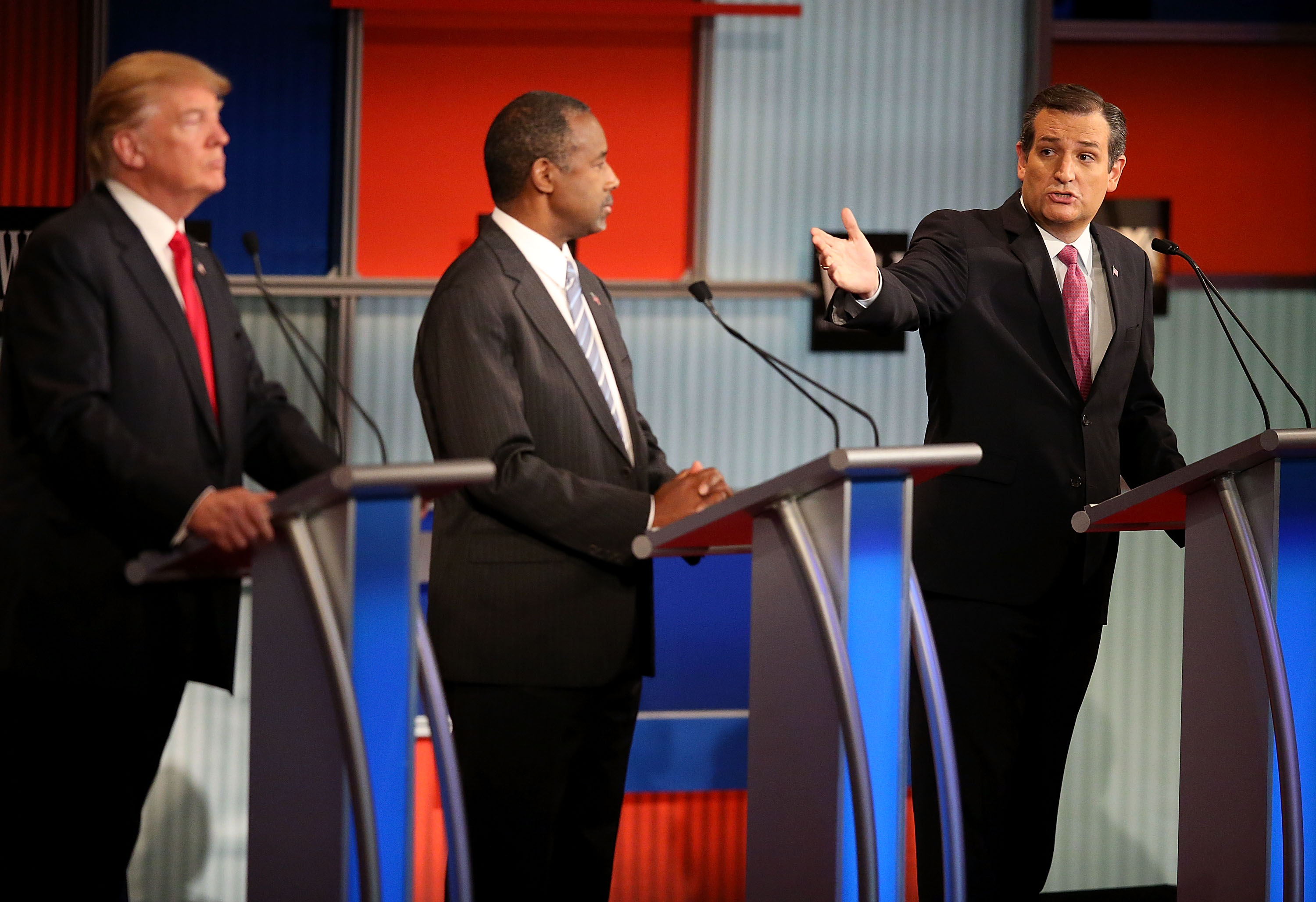 Republican presidential candidate Donald Trump (L) and Ben Carson (C) looks on as U.S. Sen. Ted Cruz (R-TX) speaks during the Republican Presidential Debate on Nov. 10.