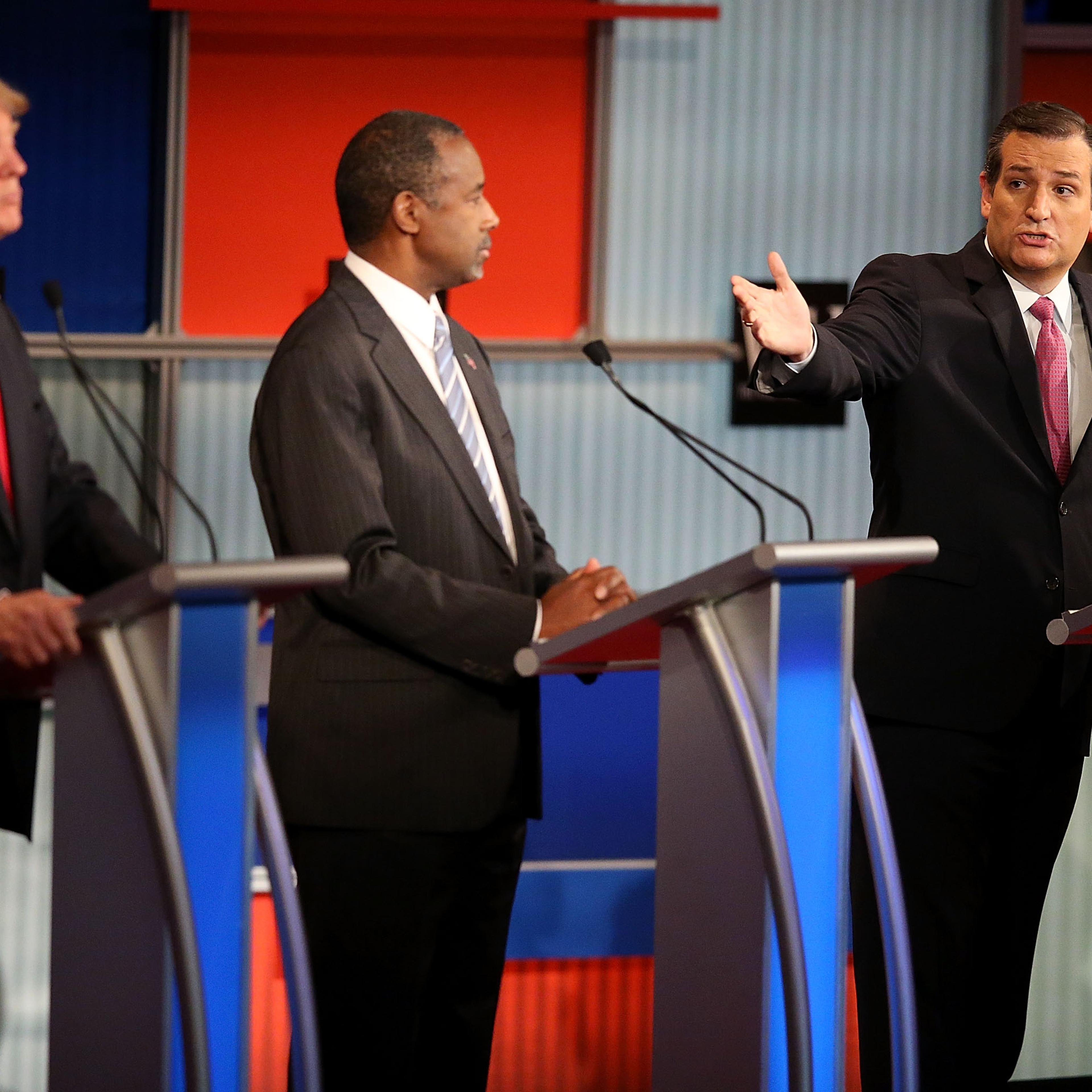 Republican presidential candidate Donald Trump (L) and Ben Carson (C) looks on as U.S. Sen. Ted Cruz (R-TX) speaks during the Republican Presidential Debate on Nov. 10.