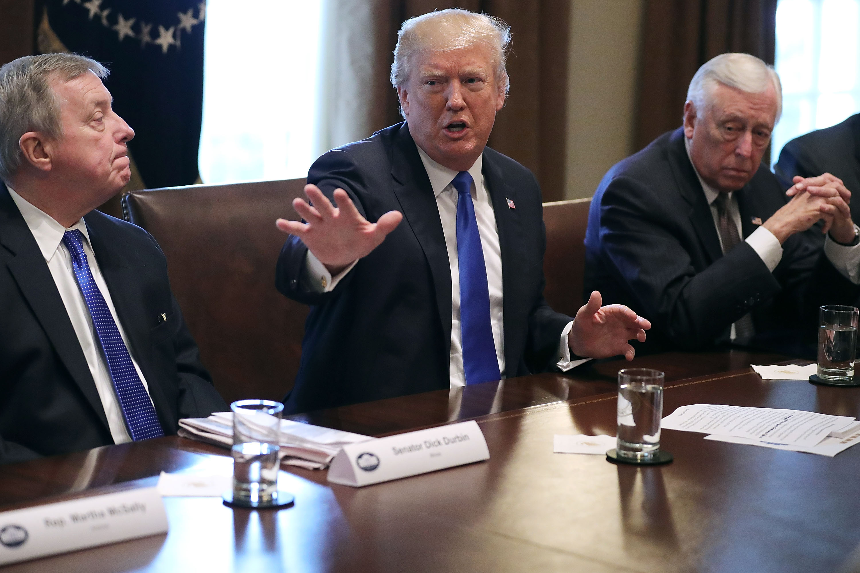 U.S. President Donald Trump (C) presides over a meeting about immigration with Republican and Democrat members of Congress, including Senate Minority Whip Richard Durbin (D-IL) (L) and House Minority Whip Steny Hoyer (D-MD) in the Cabinet Room at the Whi