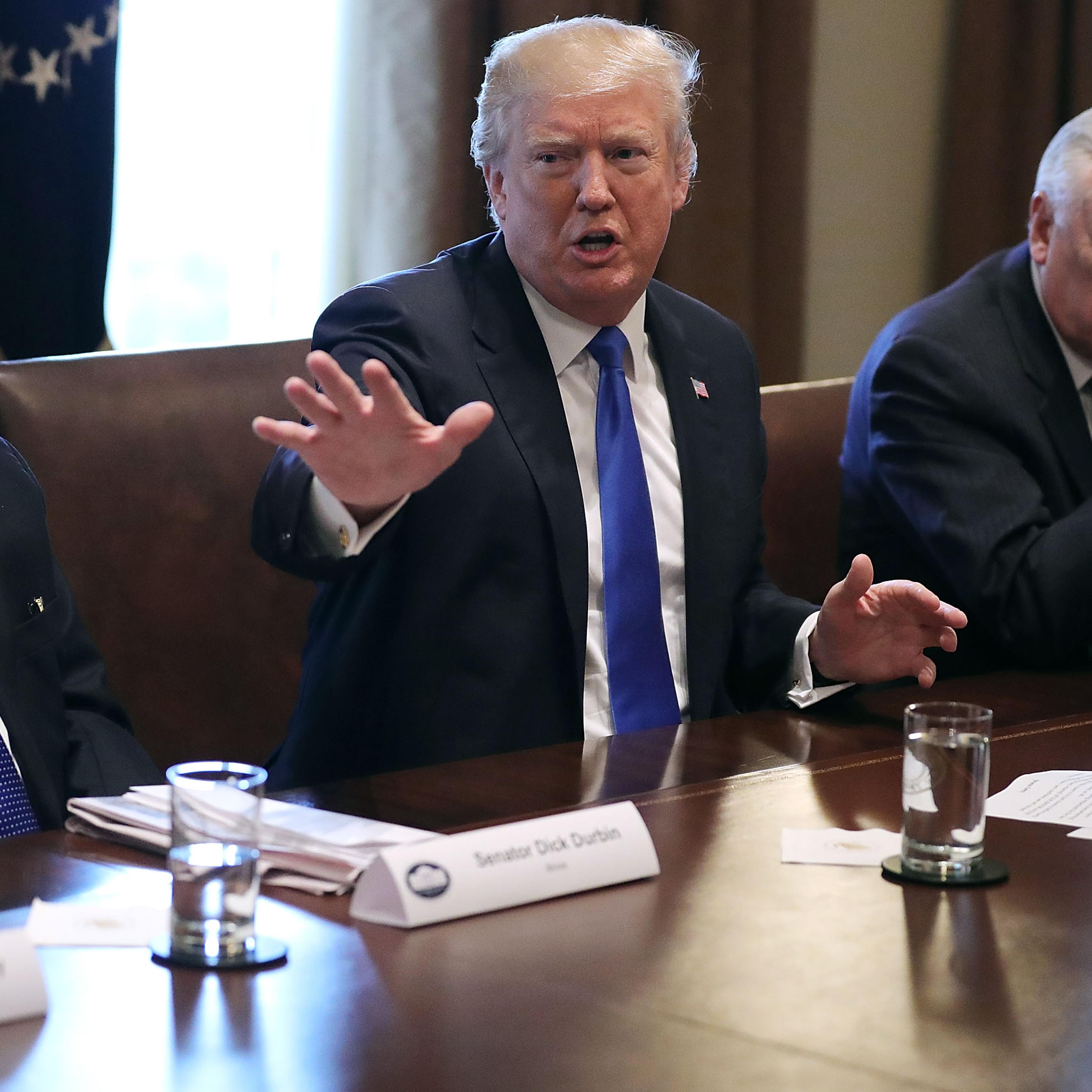 U.S. President Donald Trump (C) presides over a meeting about immigration with Republican and Democrat members of Congress, including Senate Minority Whip Richard Durbin (D-IL) (L) and House Minority Whip Steny Hoyer (D-MD) in the Cabinet Room at the Whi