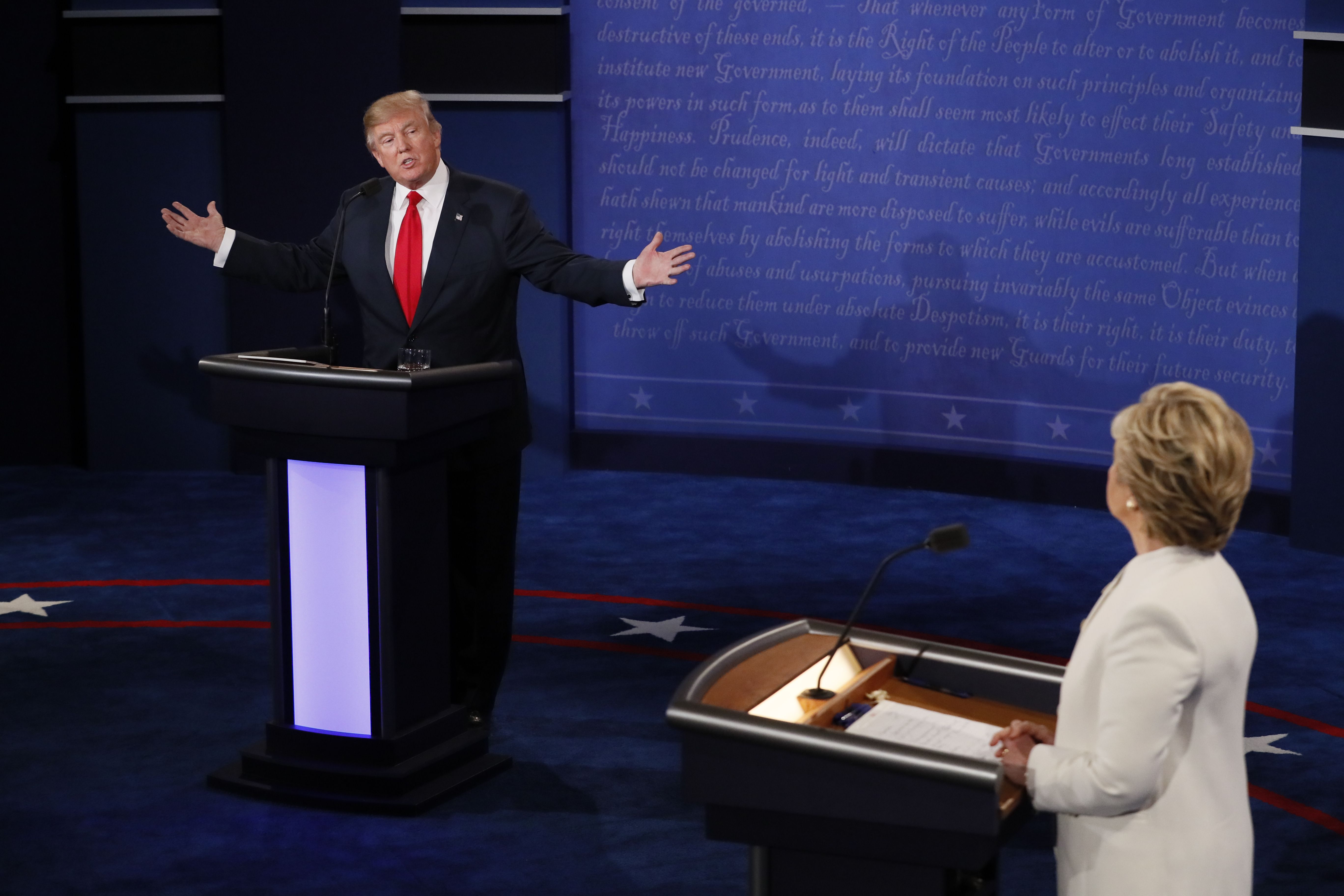Republican presidential nominee Donald Trump speaks as Democratic presidential nominee Hillary Clinton (R) looks on during the final presidential debate at the Thomas & Mack Center on the campus of the University of Las Vegas in Las Vegas on Oct. 19, 201