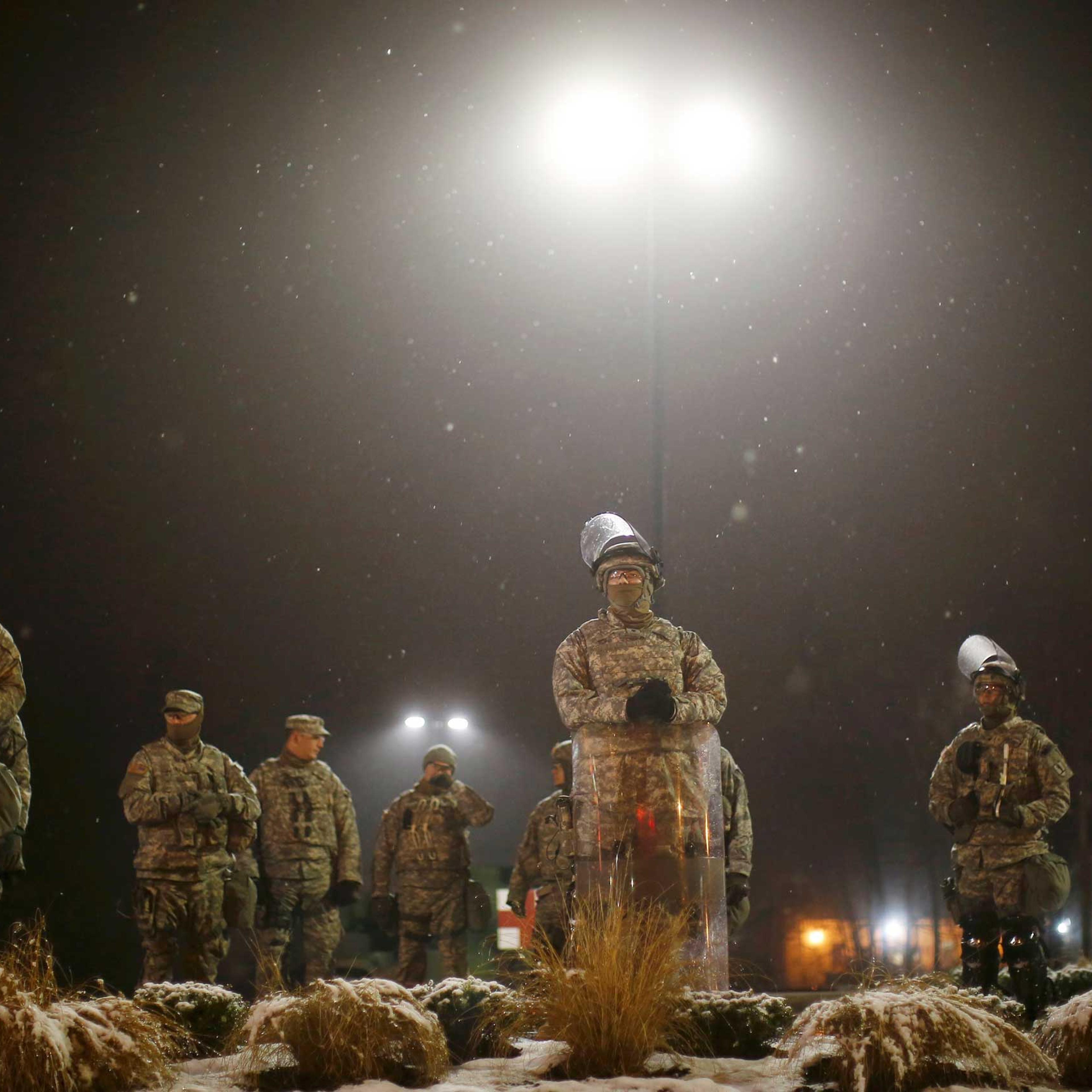 Missouri National Guardsmen stand guard at the Ferguson Police Station in Ferguson Missouri