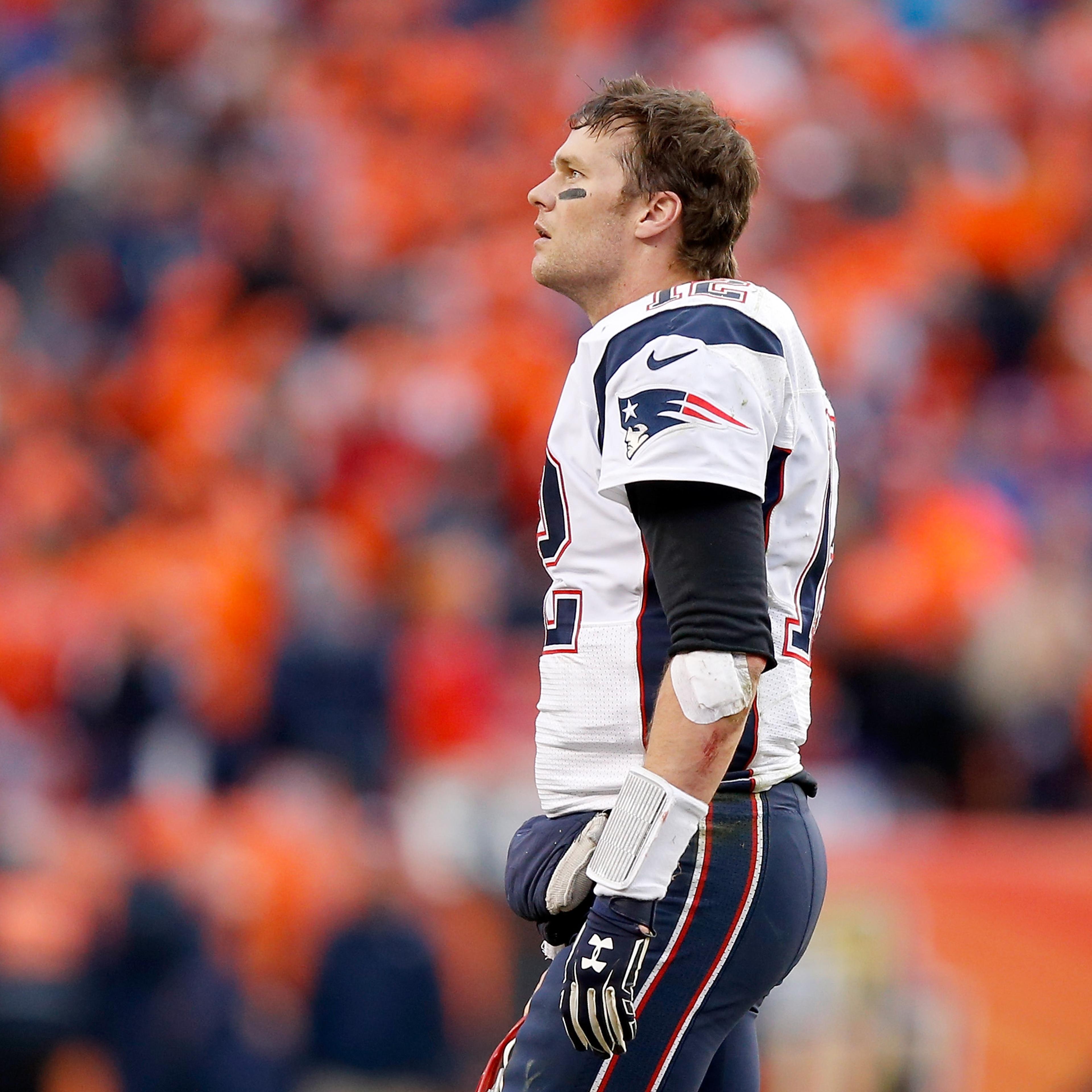 Tom Brady #12 of the New England Patriots looks on in the second half against the Denver Broncos in the AFC Championship game at Sports Authority Field at Mile High on January 24, 2016 in Denver, Colorado.