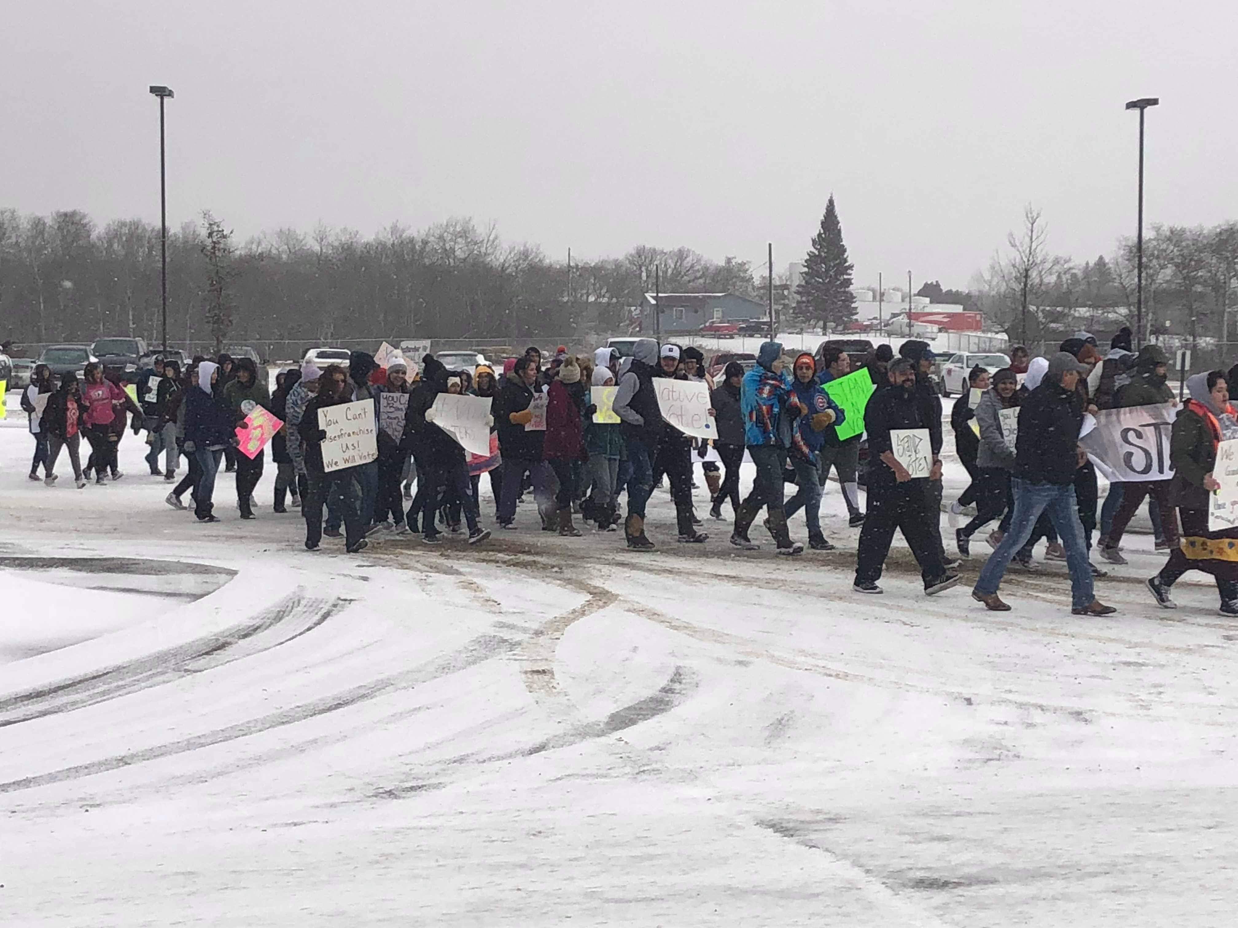 Members of the Turtle Mountain youth council and tribal leaders march to a polling site near Belcourt, N.D. on Nov. 6, 2018.