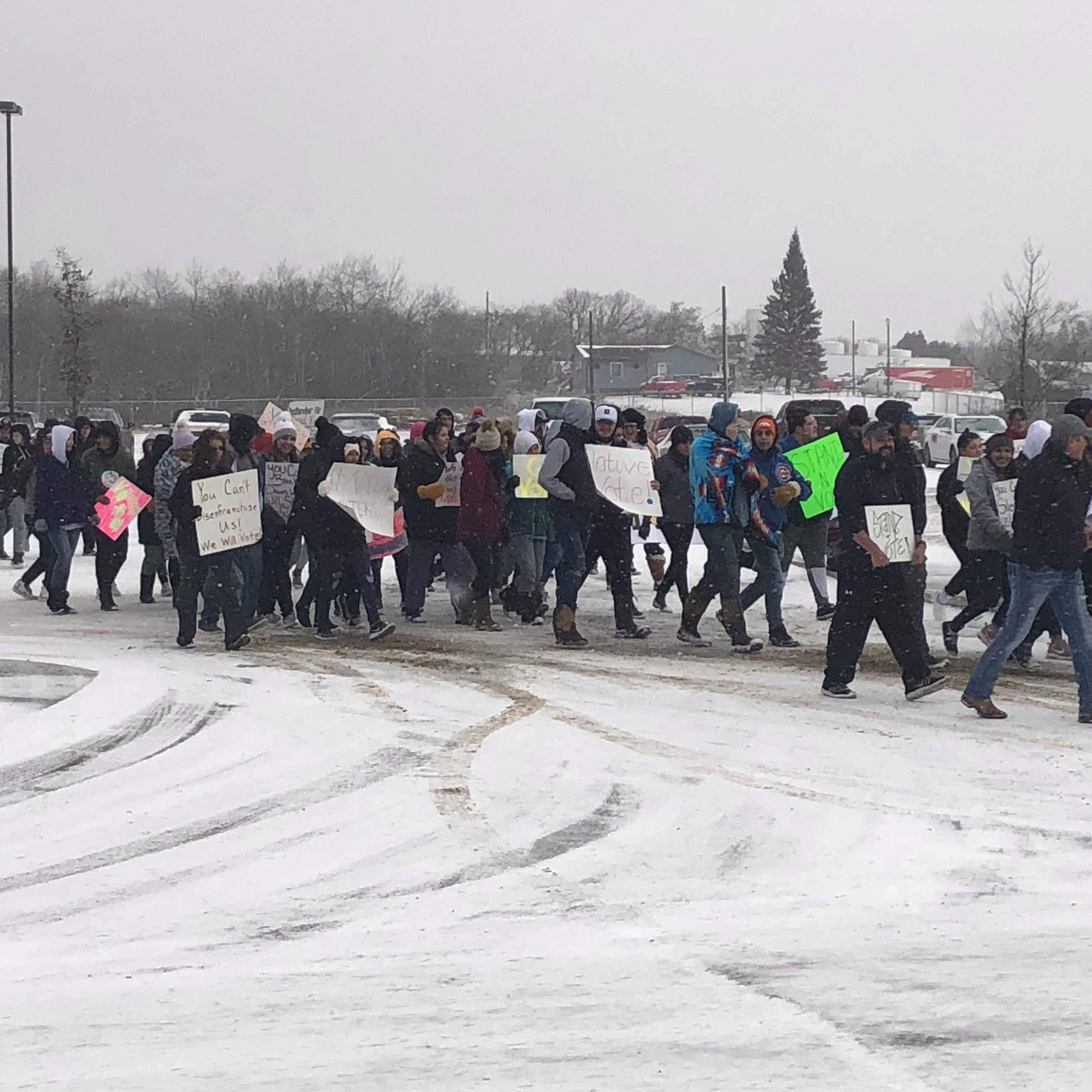 Members of the Turtle Mountain youth council and tribal leaders march to a polling site near Belcourt, N.D. on Nov. 6, 2018.