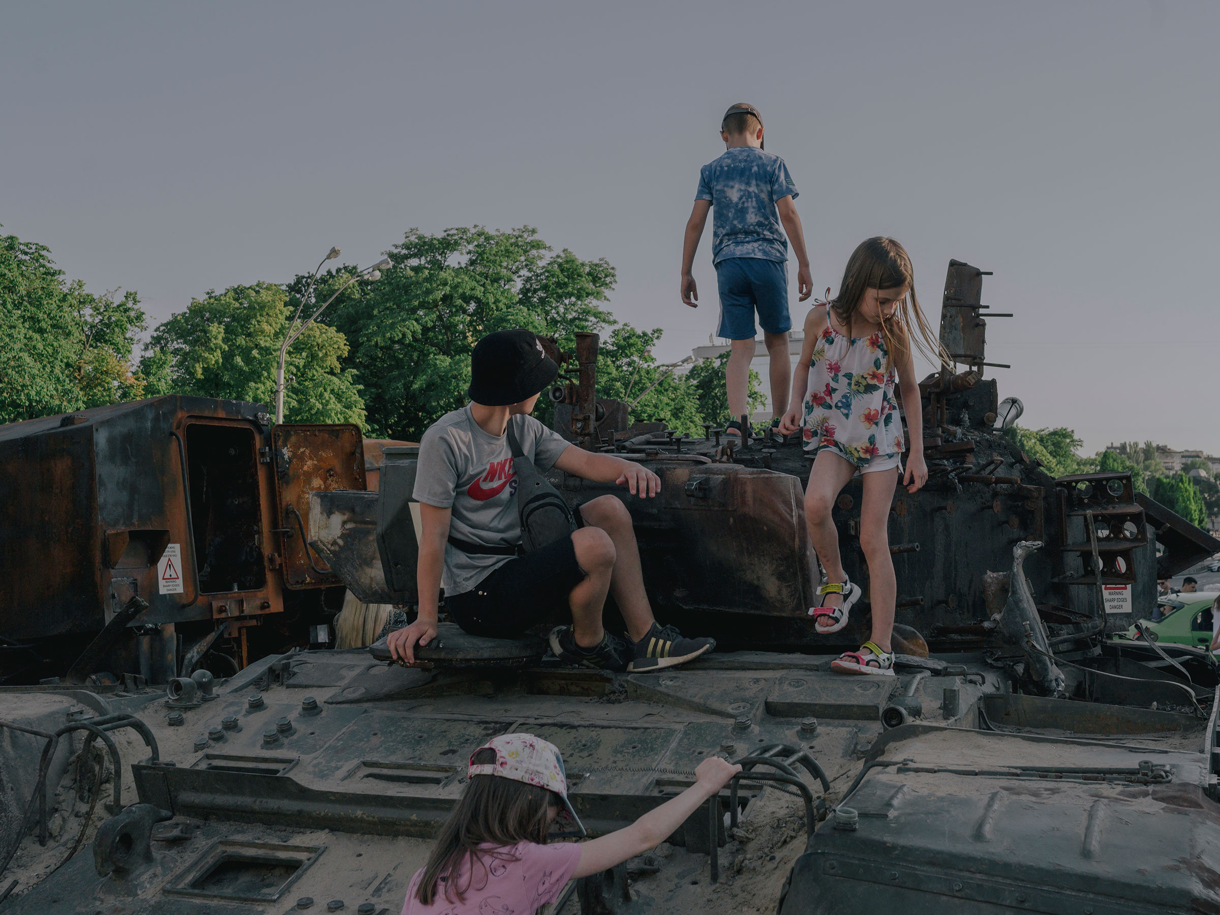 Children play on destroyed Russian war equipment in front of St. Michael‘s Monastery in Kyiv on June 12, 2022.