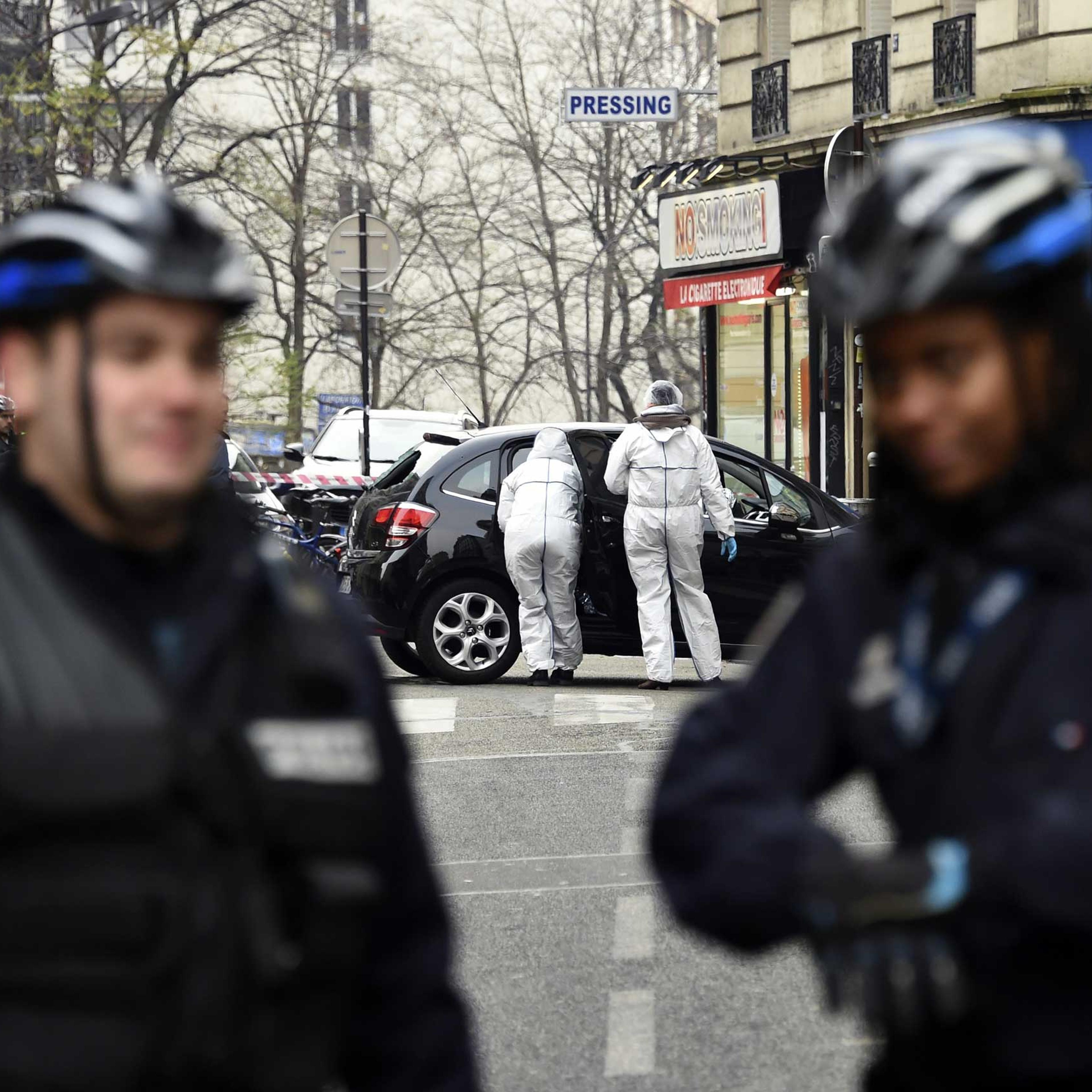 French police officers and forensic experts examine the car used by armed gunmen who stormed the Paris offices of satirical newspaper Charlie Hebdo on Jan. 7, 2015 in Paris.