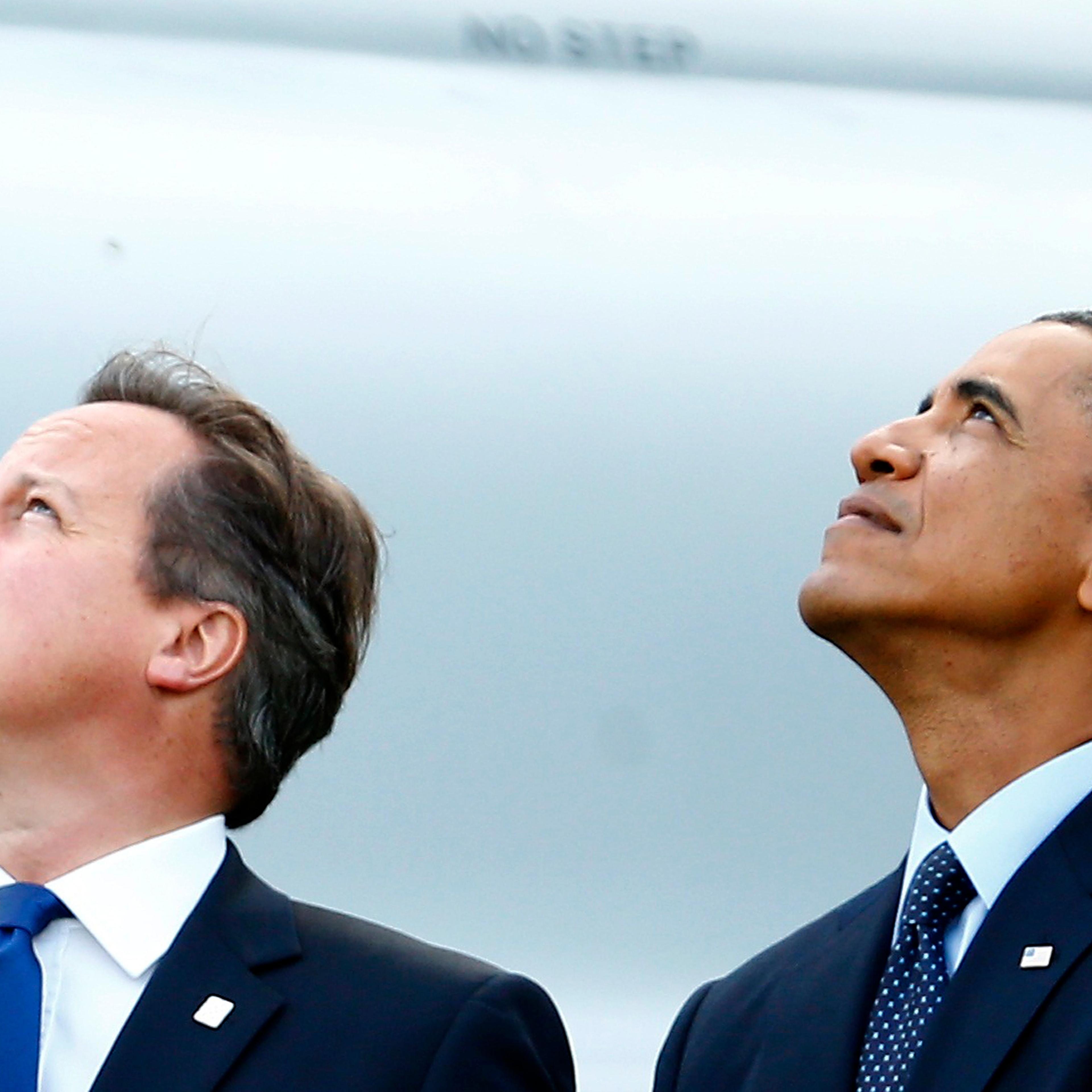 Britain's Prime Minister David Cameron and U.S. President Barack Obama watch a fly-past by the Red Arrows during the NATO summit at the Celtic Manor resort, near Newport