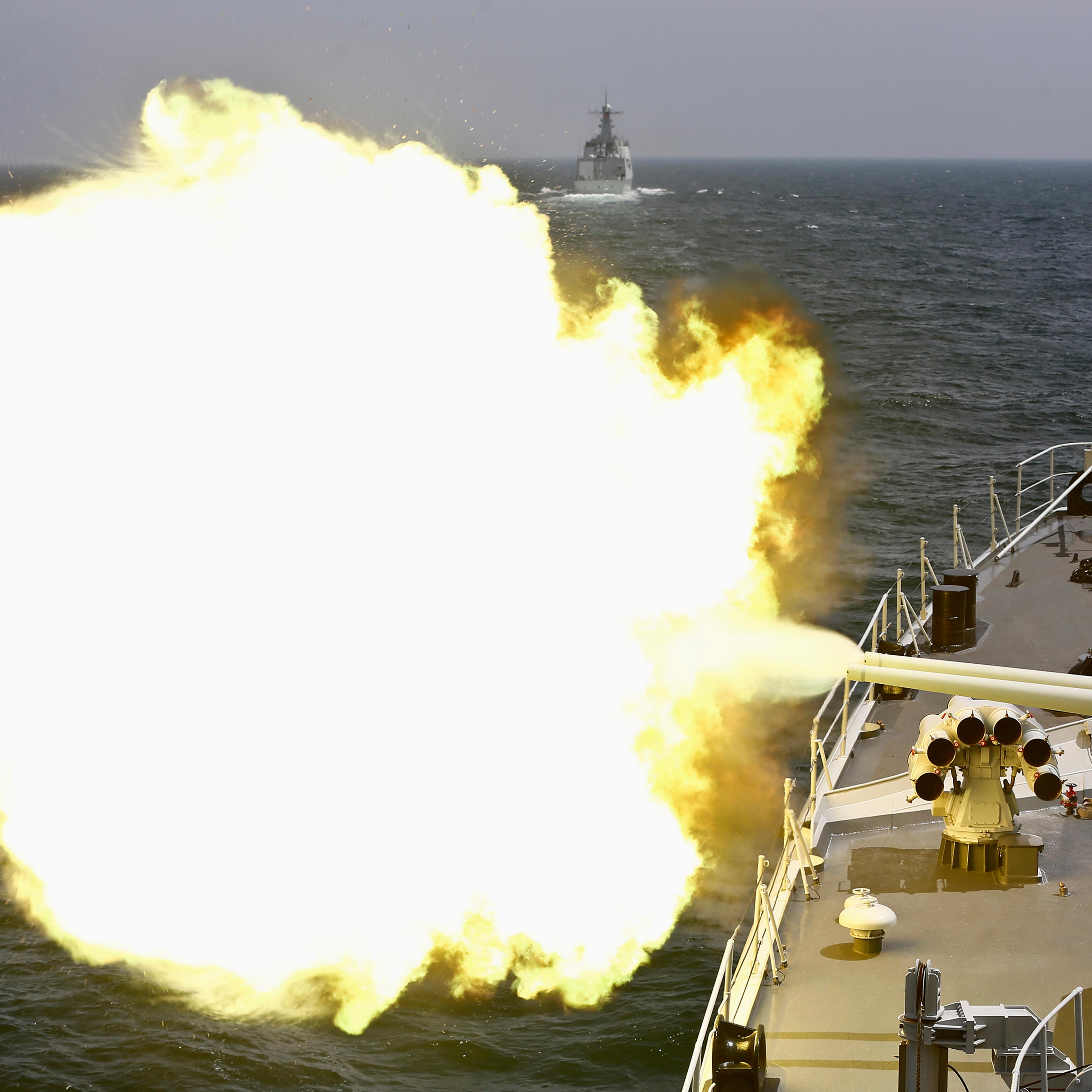 A Chinese navy vessel fires its cannon during the Joint Sea-2014 naval drill outside Shanghai on the East China Sea