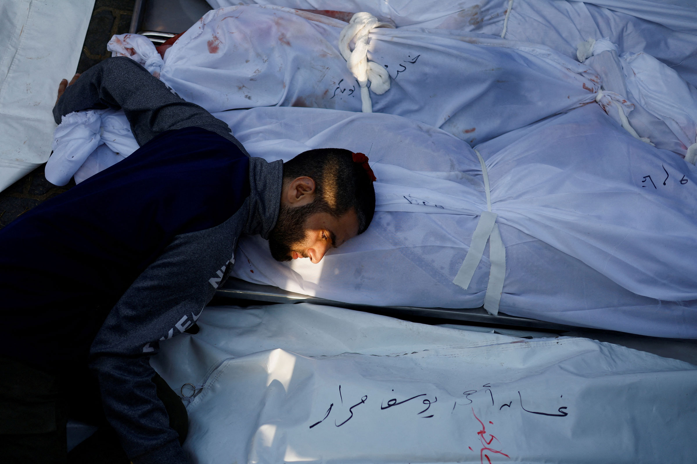 A man mourns as he attends a funeral of Palestinians killed in Israeli strikes
