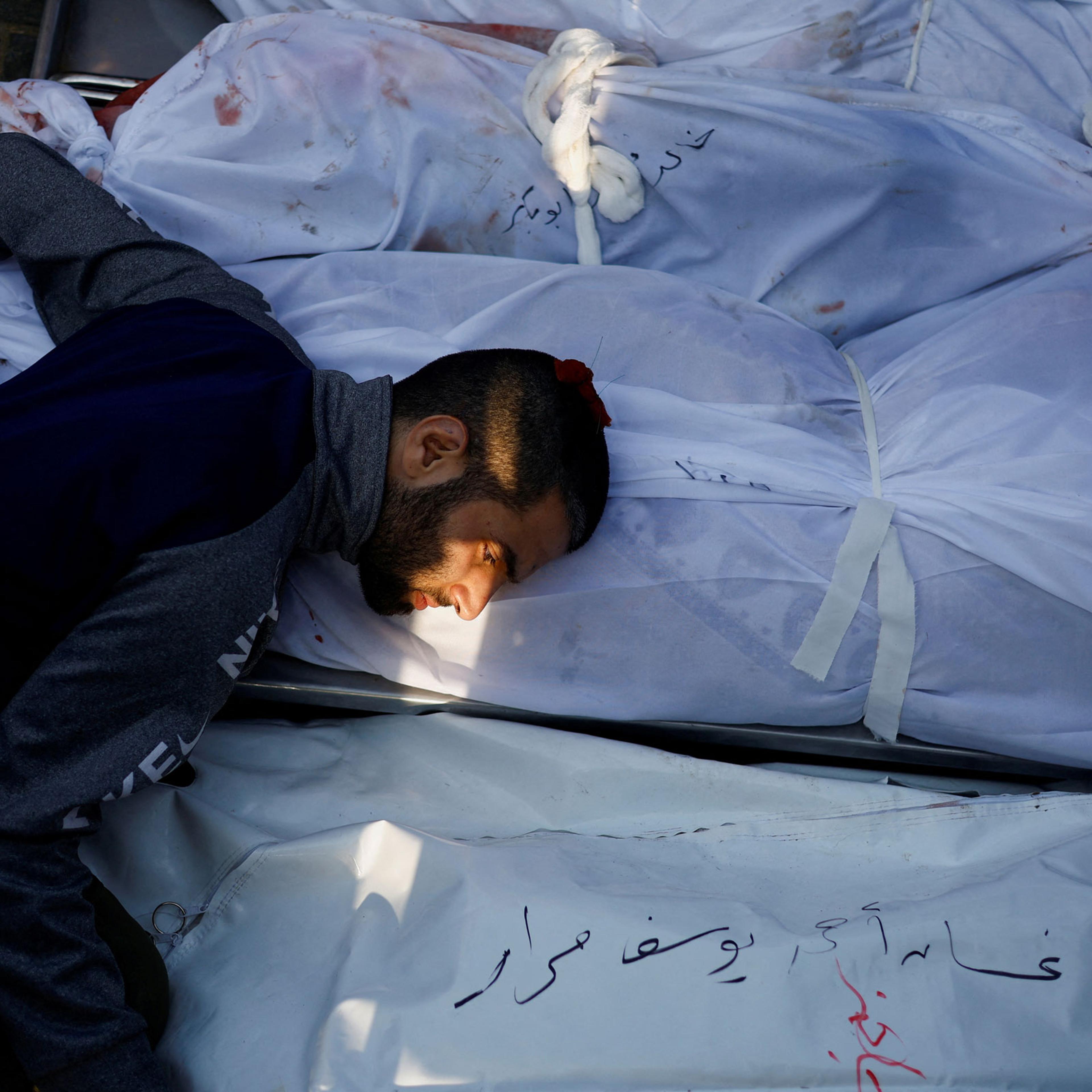 A man mourns as he attends a funeral of Palestinians killed in Israeli strikes