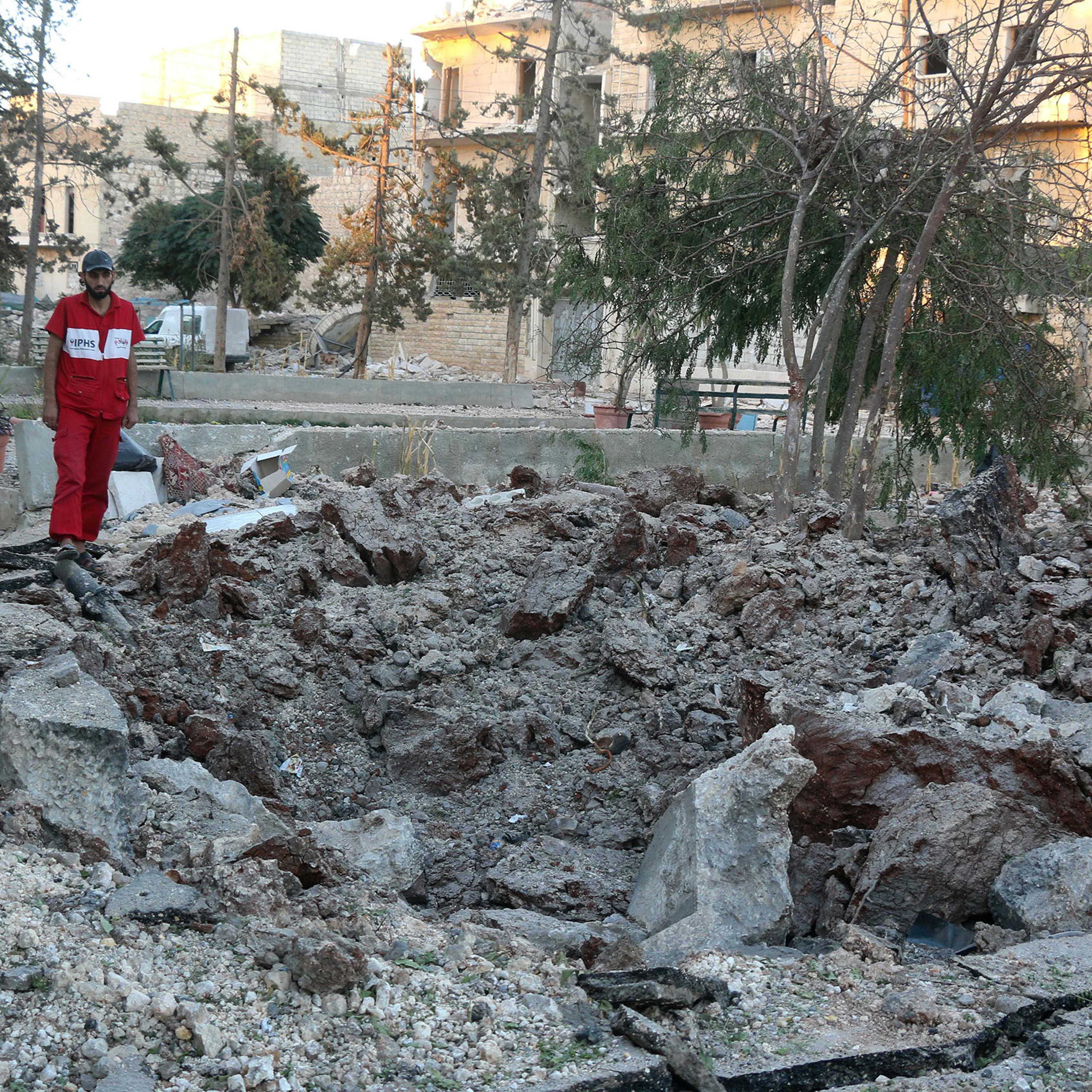 A Syrian medical staff member inspects the damage at the site of a medical facility after it was reportedly hit by Syrian regime barrel bombs on Oct. 1, 2016, in the rebel-held neighbourhood of al-Sakhour, in the northern city of Aleppo.