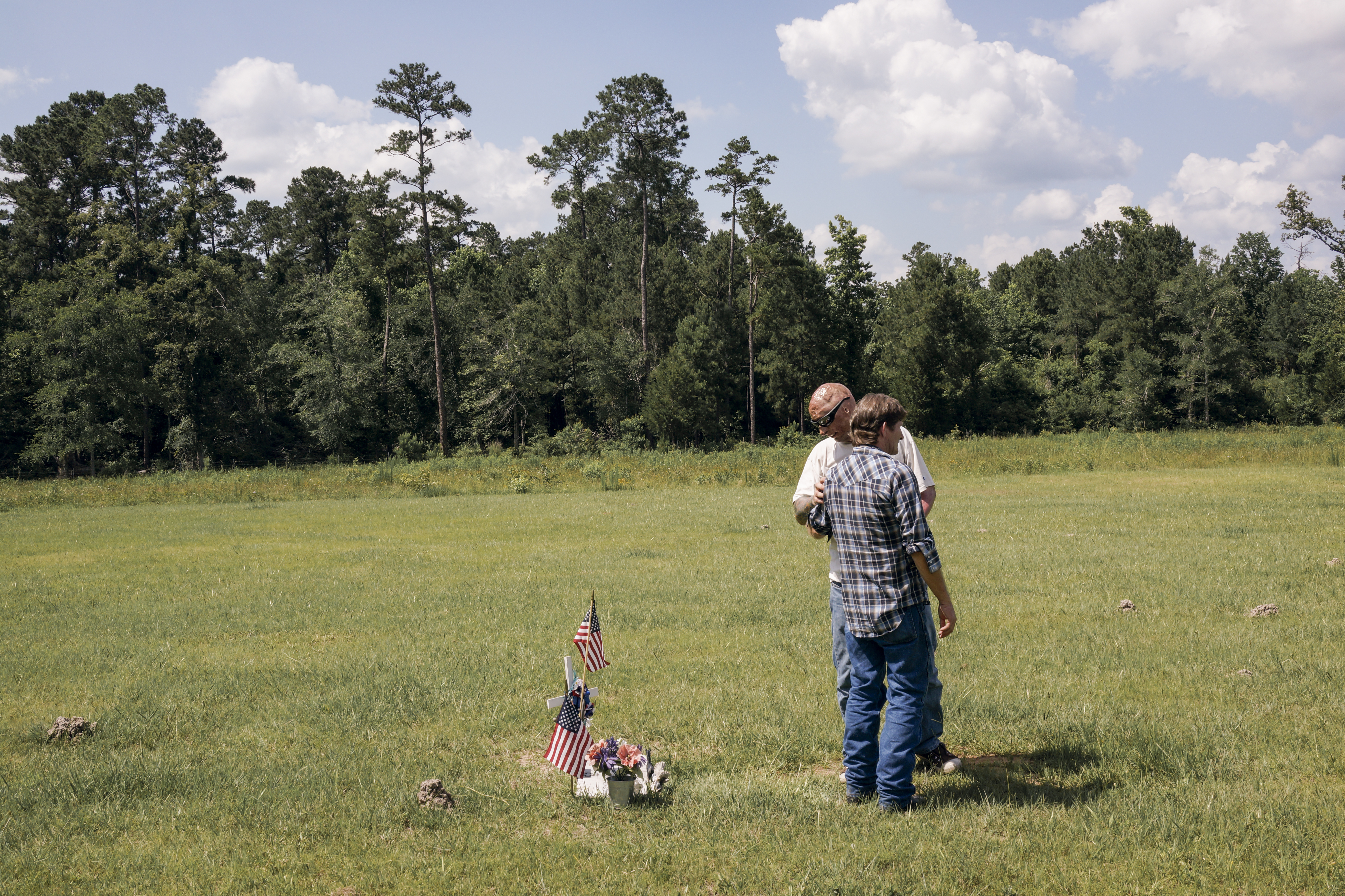 2013. Livingston, TX. USA. Bobby and Lynn McCandless at the grave of Lynn's son, Rodney. Rodney was killed in the IED explosion that injured Bobby. For years McCandless's family didn't know that anyone had survived the attack until Bobby was able to reac