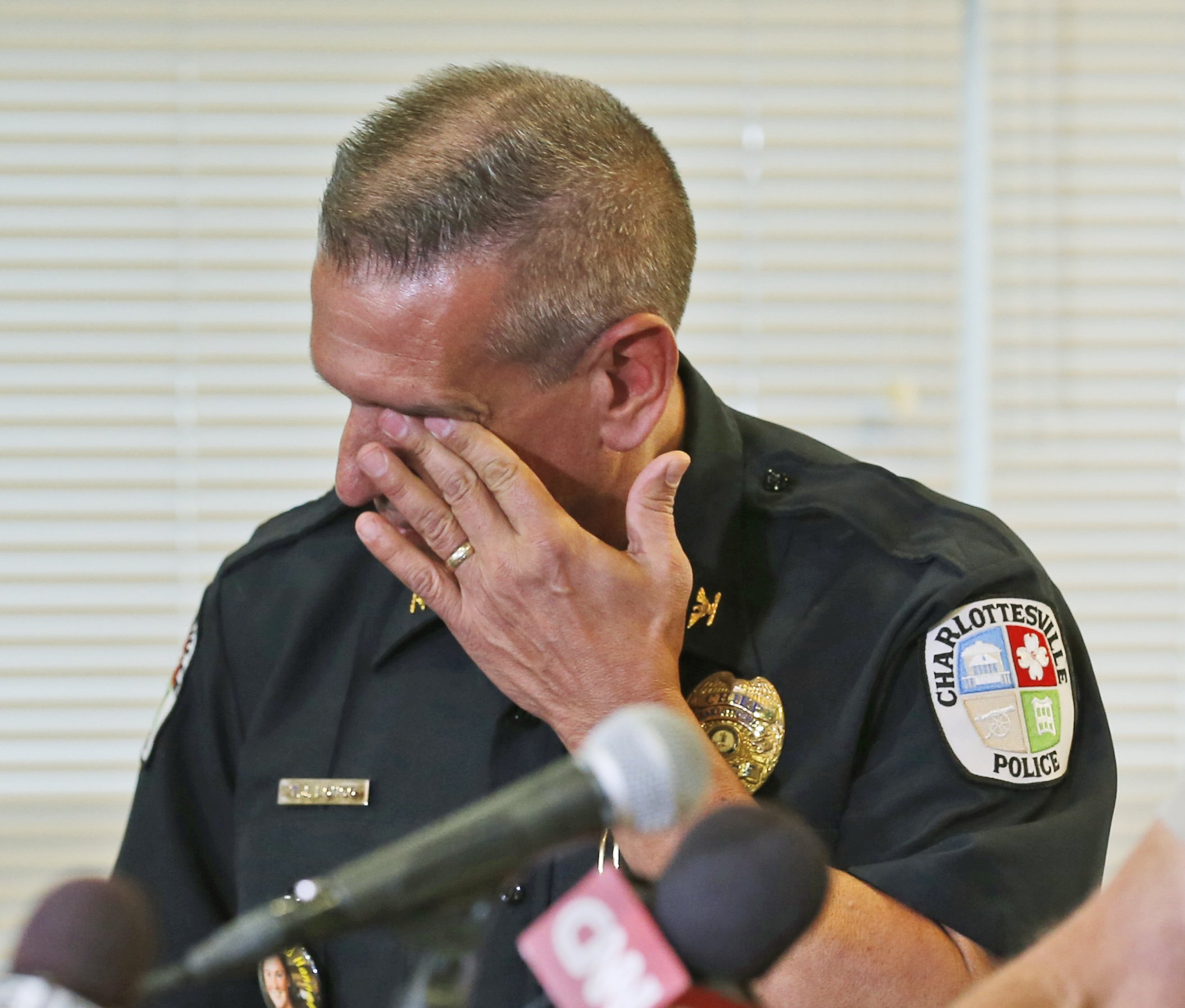 Charlottesville Police Chief, Tim Longo, wipes his eyes as he and Albermarle County police Col. Steve Sellers, brief the media on the discovery of remains in Albermarle County during a news conference in Charlottesville, Va. on Oct. 18, 2014. Searchers f
