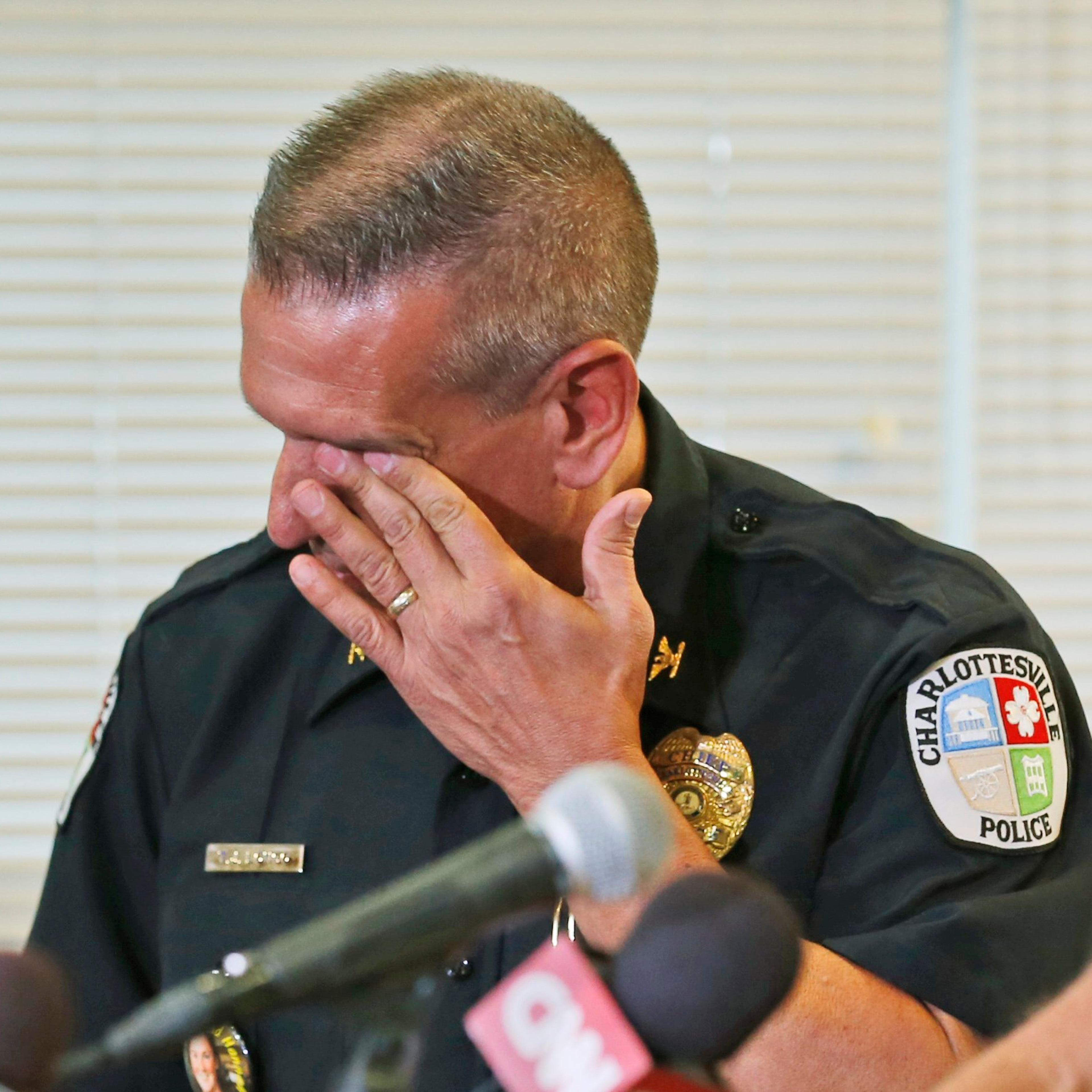 Charlottesville Police Chief, Tim Longo, wipes his eyes as he and Albermarle County police Col. Steve Sellers, brief the media on the discovery of remains in Albermarle County during a news conference in Charlottesville, Va. on Oct. 18, 2014. Searchers f