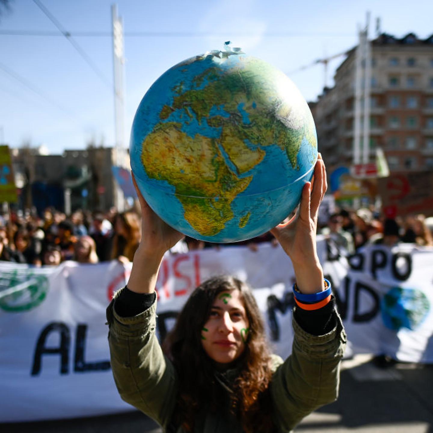 Protester holds a small globe during the global climate strike on March 3, 2023 in Turin, Italy.