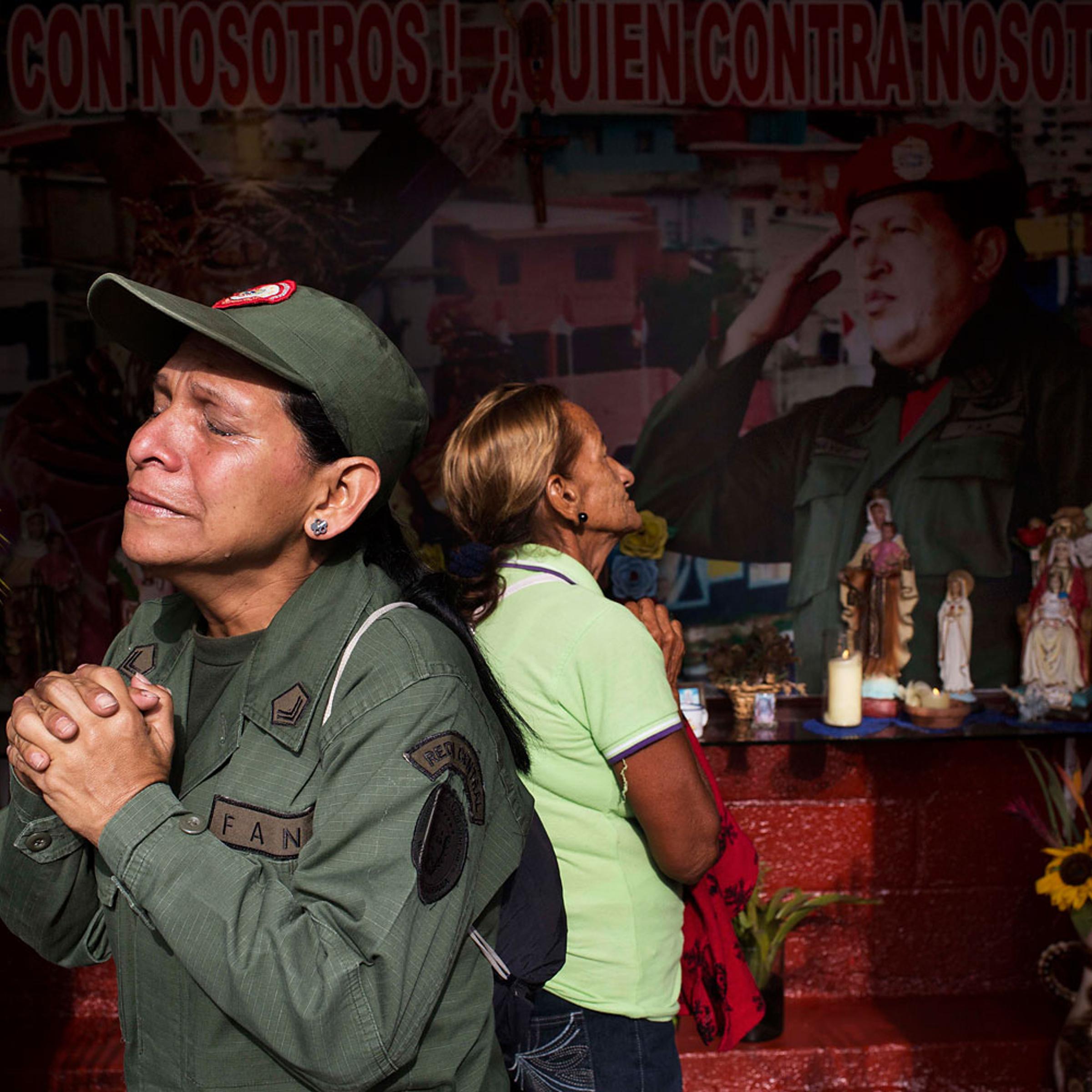 Marisol Perez, Venezuelan Army specialist, cries while visiting a chapel near Venezuela's late President Hugo Chavez's mausoleum in Caracas, March 5, 2014.