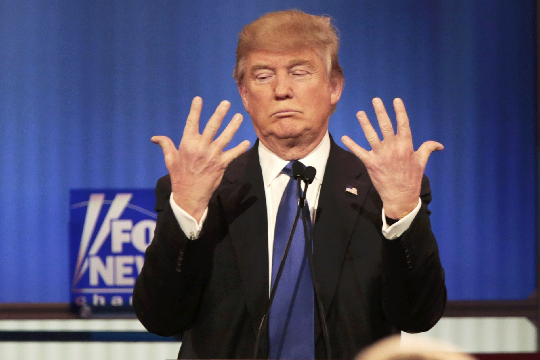 Republican presidential candidate Donald Trump shows off the size of his hands during a debate in Detroit, on March 3.