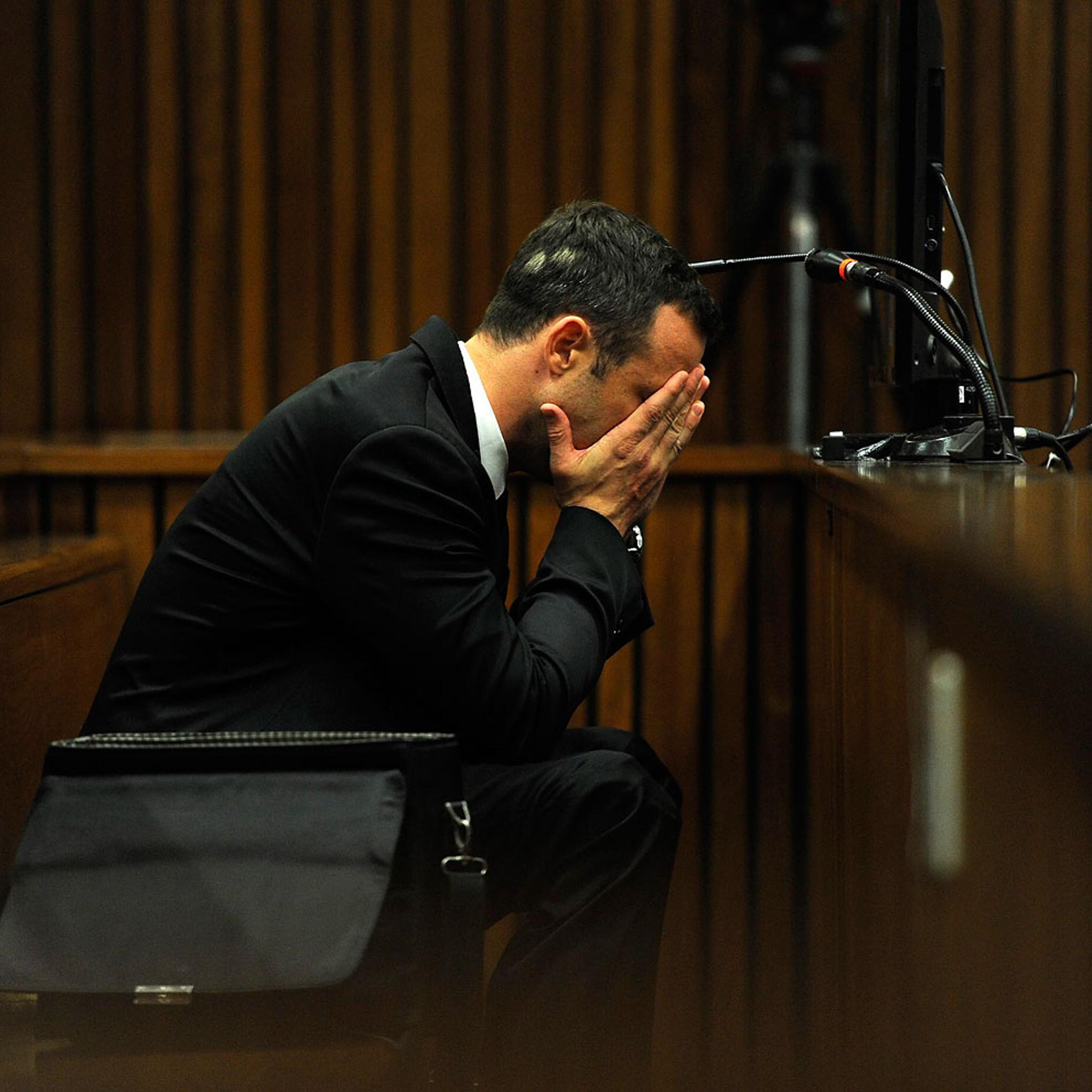 Olympic and Paralympic track star Oscar Pistorius reacts during the fourth day of his trial for the murder of his girlfriend Reeva Steenkamp at the North Gauteng High Court in Pretoria, March 6, 2014.
