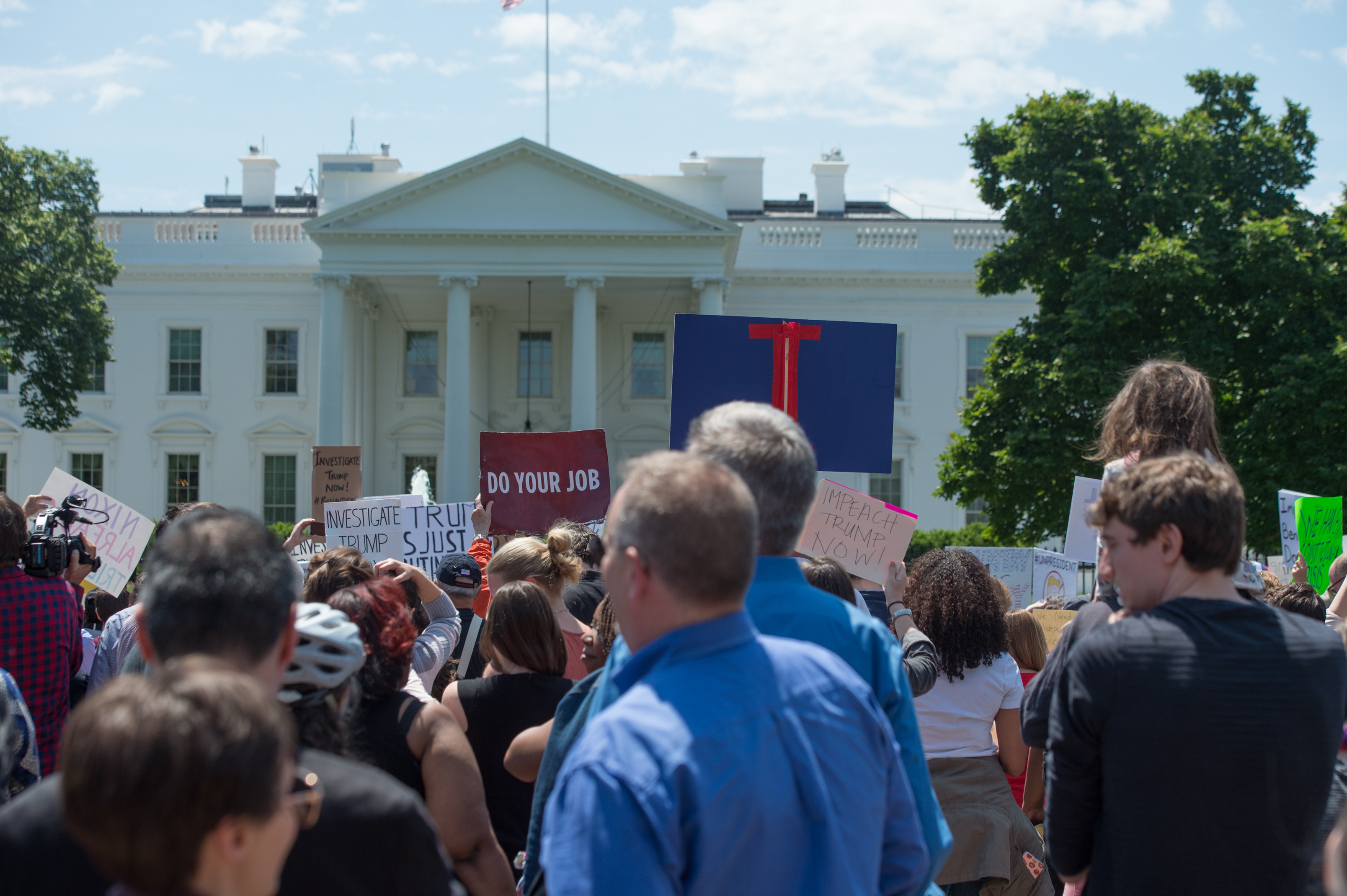 About 300 protesters arrive at the White House during a peaceful protest march the day after President Trump unexpectedly fired Director of the FBI, James Comey.