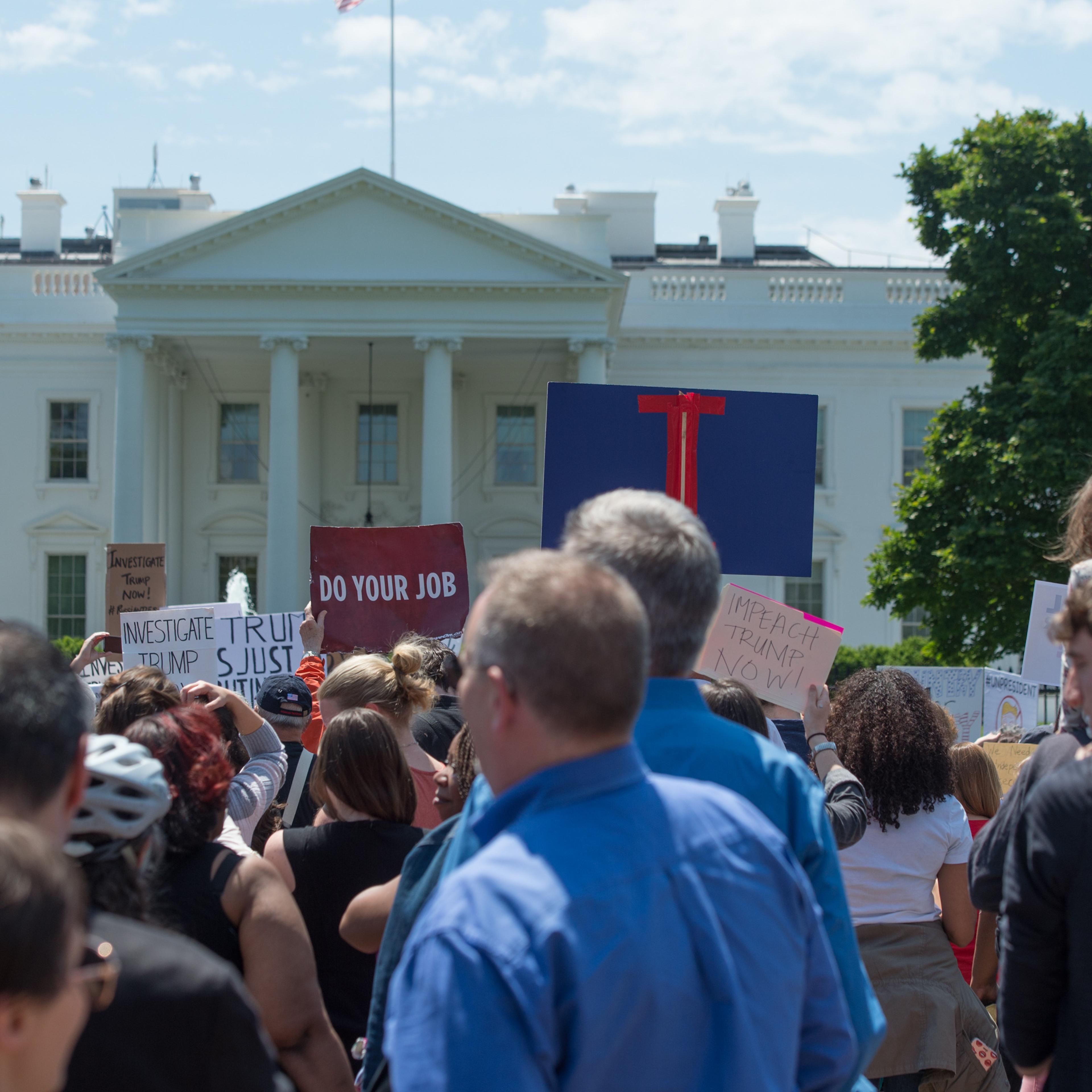 About 300 protesters arrive at the White House during a peaceful protest march the day after President Trump unexpectedly fired Director of the FBI, James Comey.