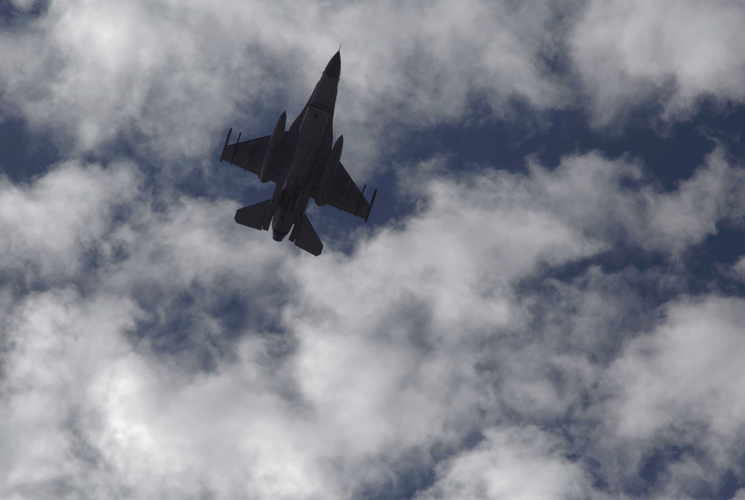 A Jordanian Air Force fighter jet flies over the village of Ai as Jordanian King Abdullah II visits to offer his condolences to the tribe of the slain Jordanian pilot, Lt. Muath al-Kaseasbeh at their home village near Karak, Jordan, Feb. 5, 2015.