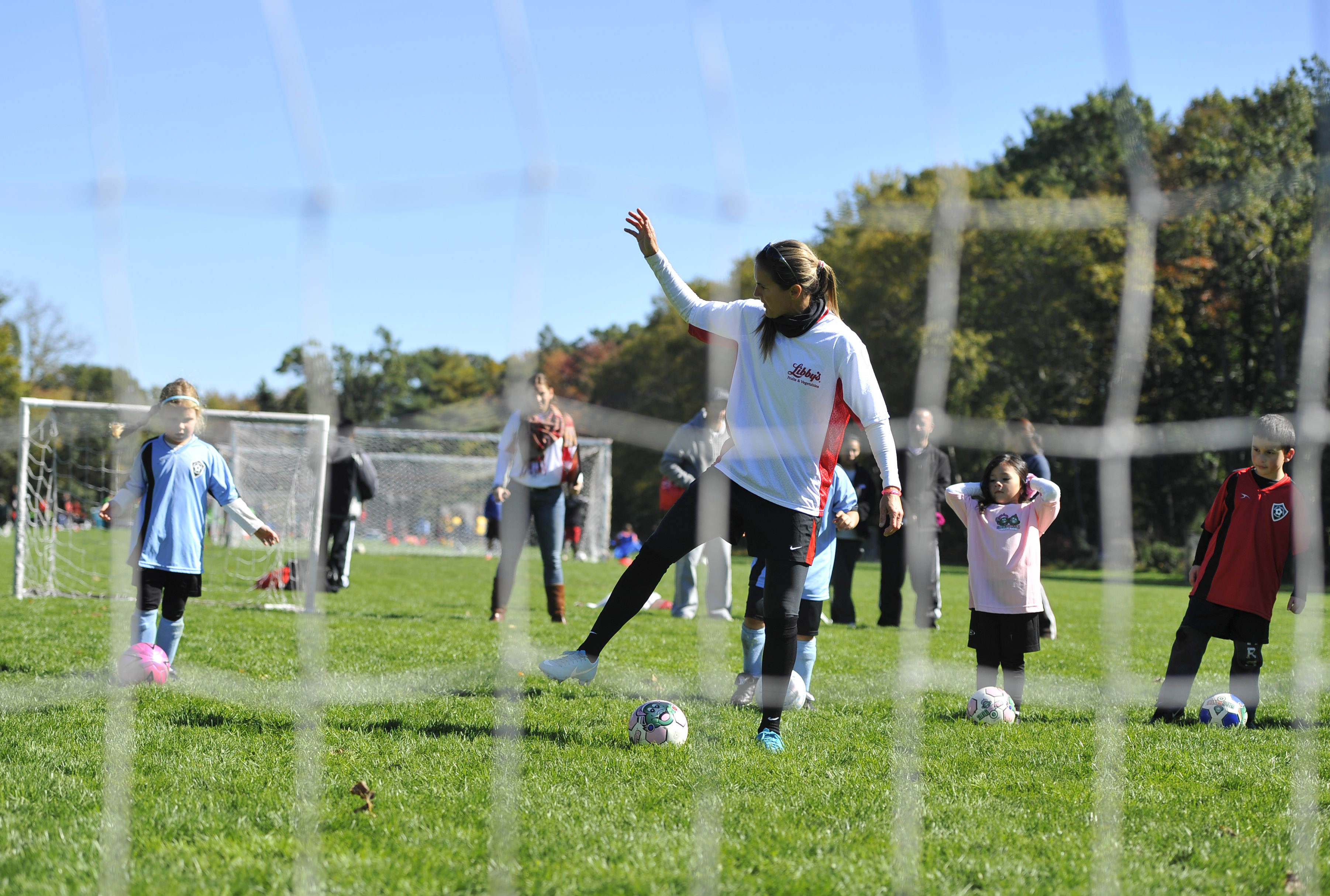Olympic soccer star Brandi Chastain offers tips to youngsters from the East Hartford Soccer Club at the Libby's Snack Duty Takeover in East Hartford, Conn., on Oct. 13, 2012.
