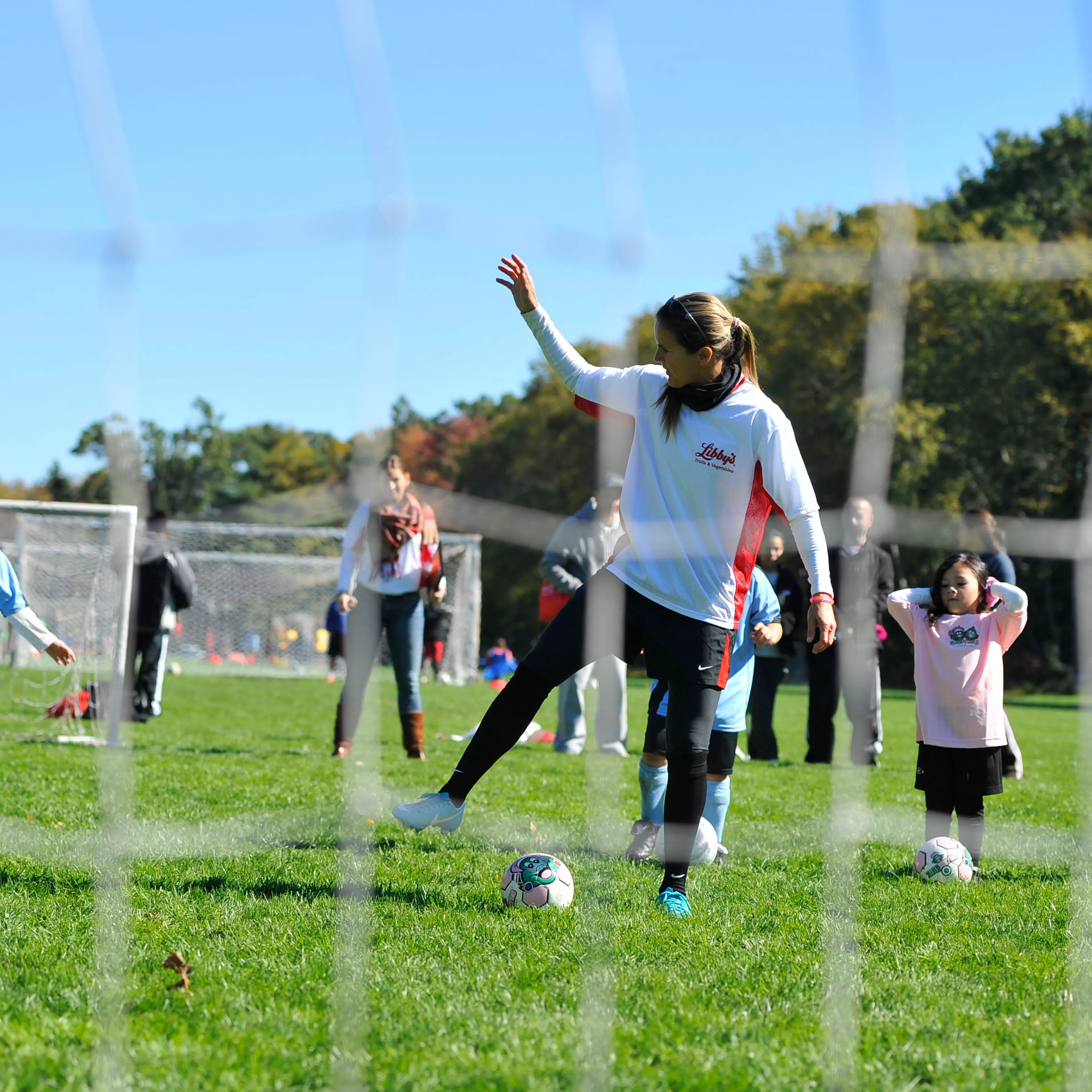 Olympic soccer star Brandi Chastain offers tips to youngsters from the East Hartford Soccer Club at the Libby's Snack Duty Takeover in East Hartford, Conn., on Oct. 13, 2012.