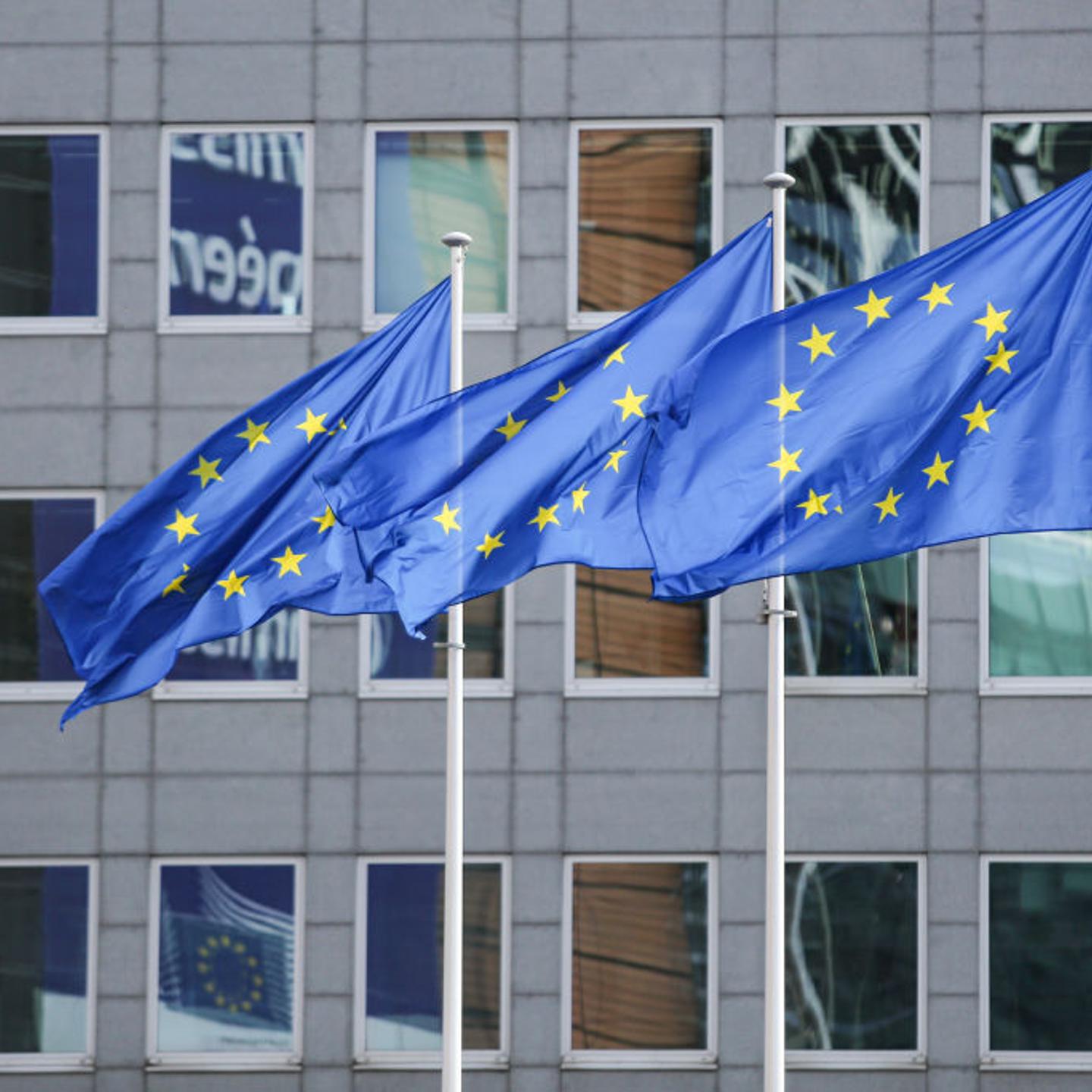 The European Flag is seen in the Belgian capital in front of modern architecture buildings with glass and steel construction of the European Commission headquarters.